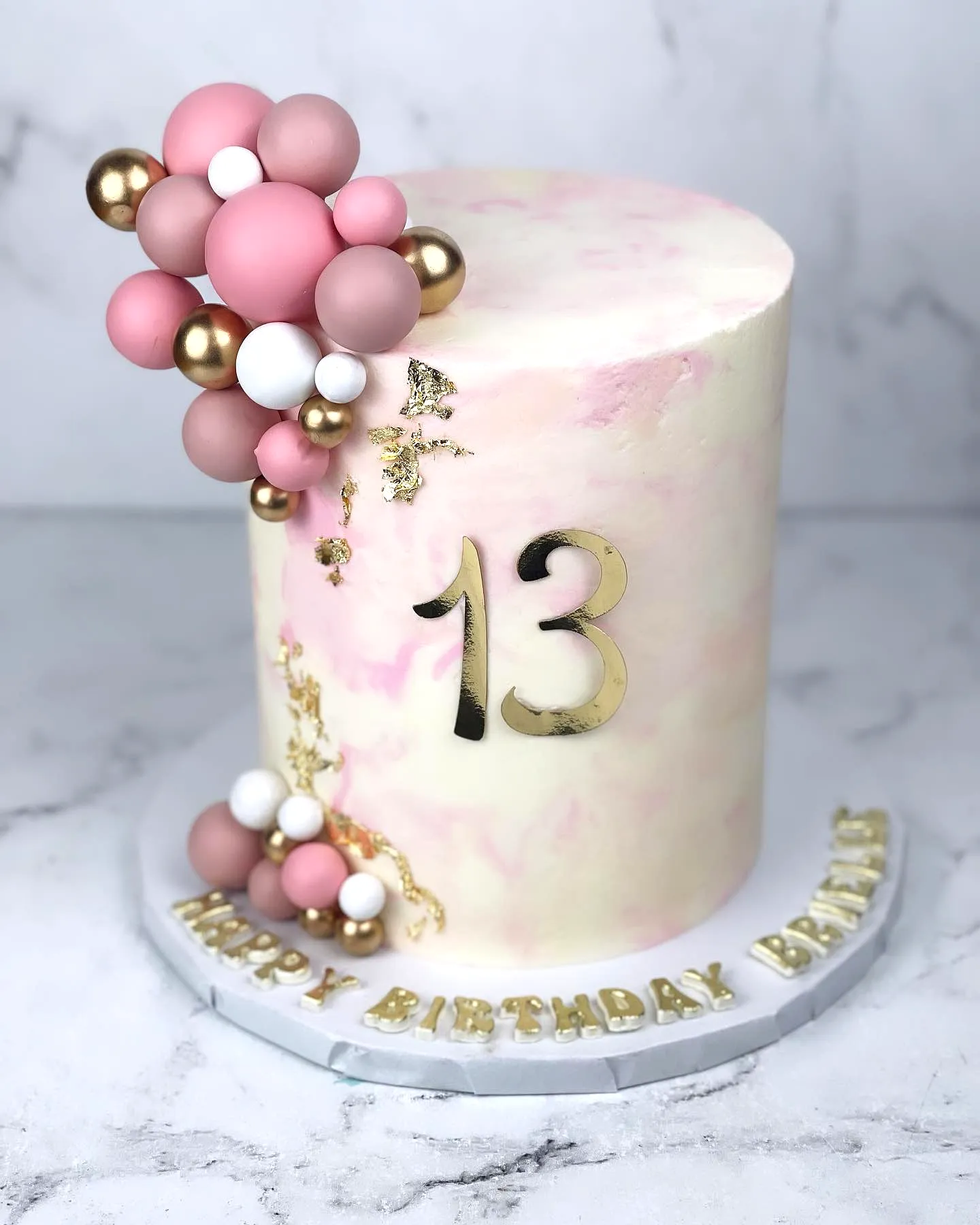 Adorable 13th Birthday Cake with Trendy Pink Marbled Frosting and Gold Accents