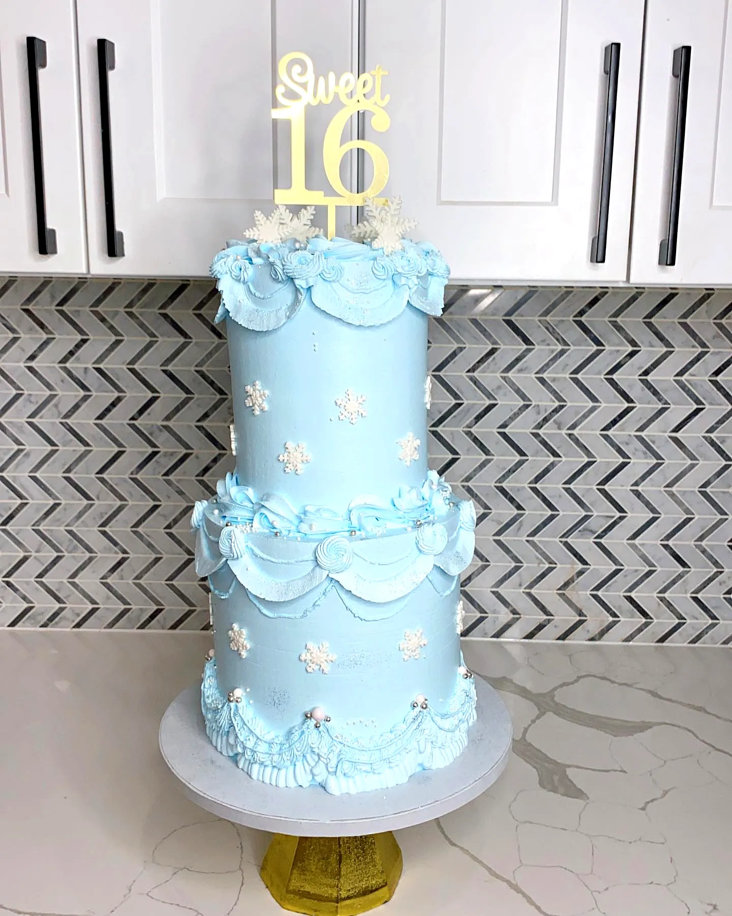 Adorable 16th birthday cake design with winter theme and soft blue frosting