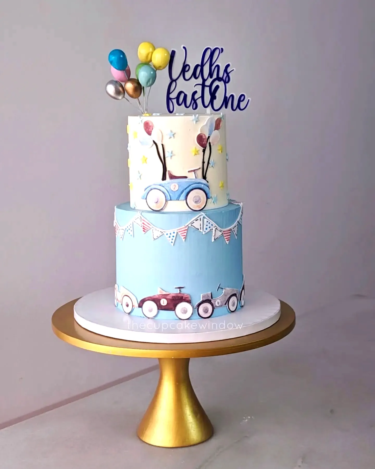 Adorable 1st Birthday Cake with Whimsical Vehicle Theme and Colorful Details