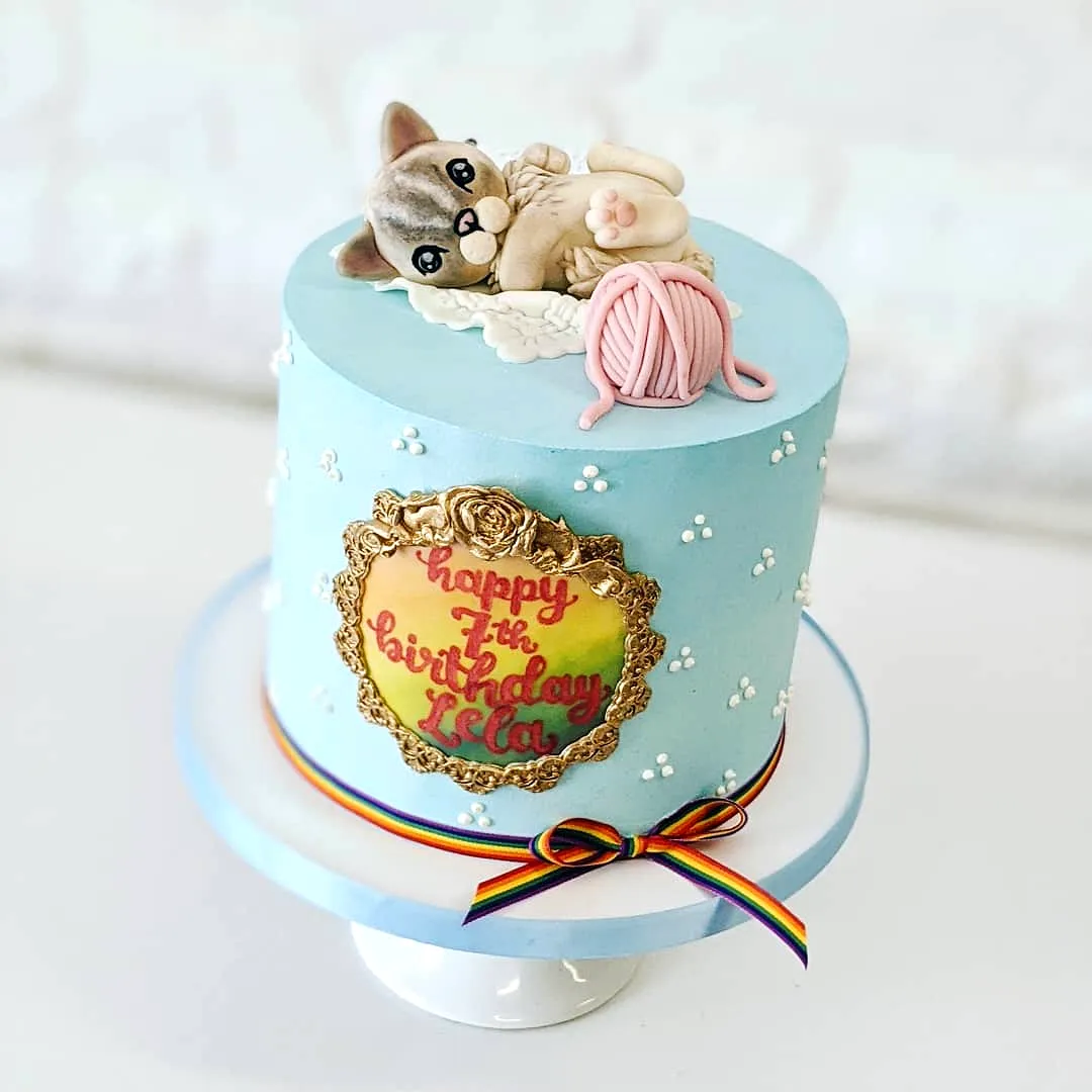 Adorable Cat Birthday Cake Design in Light Blue with Playful Decorations