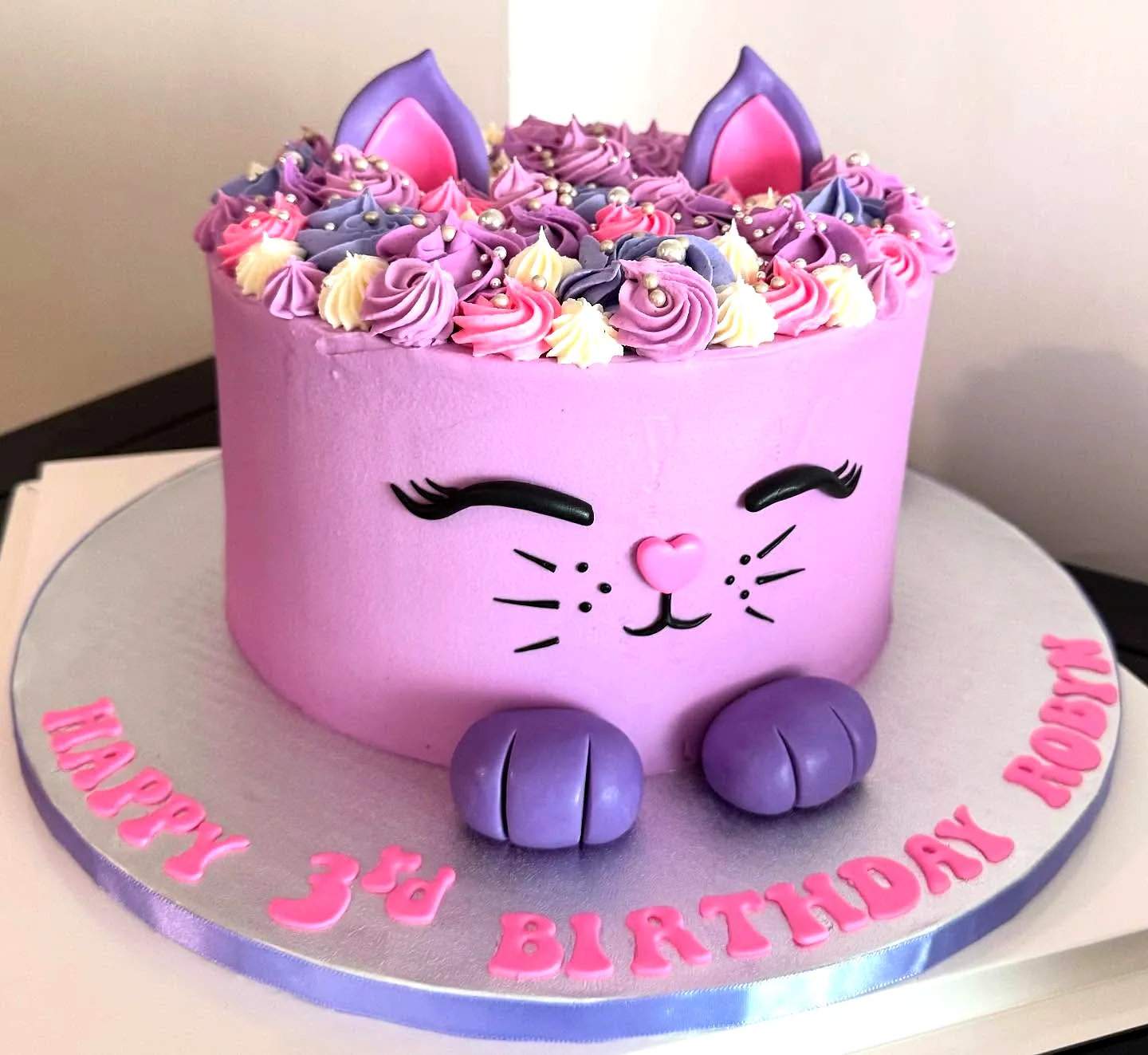Adorable Cat Birthday Cake Design in Vibrant Purple and Pastel Accents