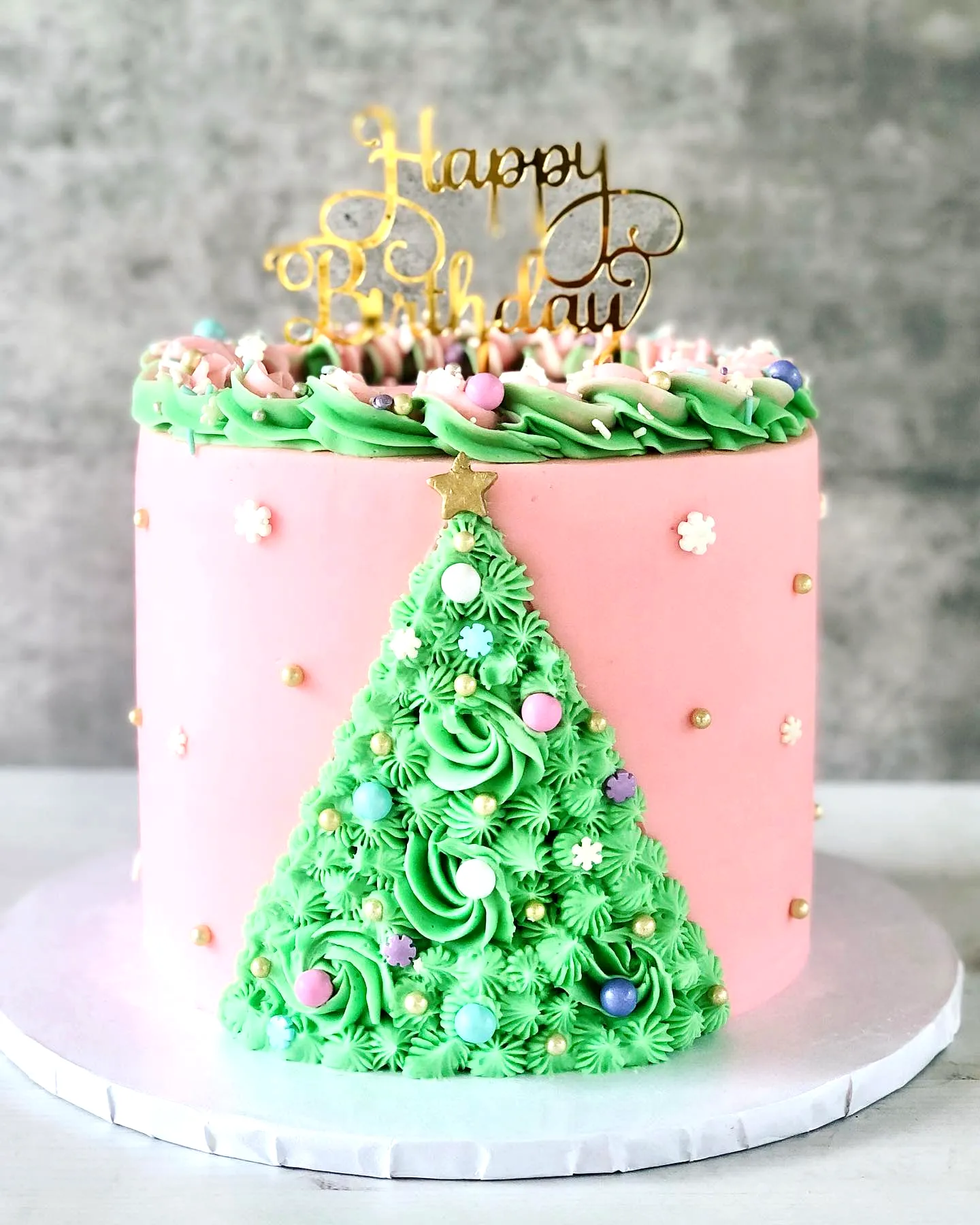 Adorable Christmas Birthday Cake with Festive Decorations and Pink Fondant