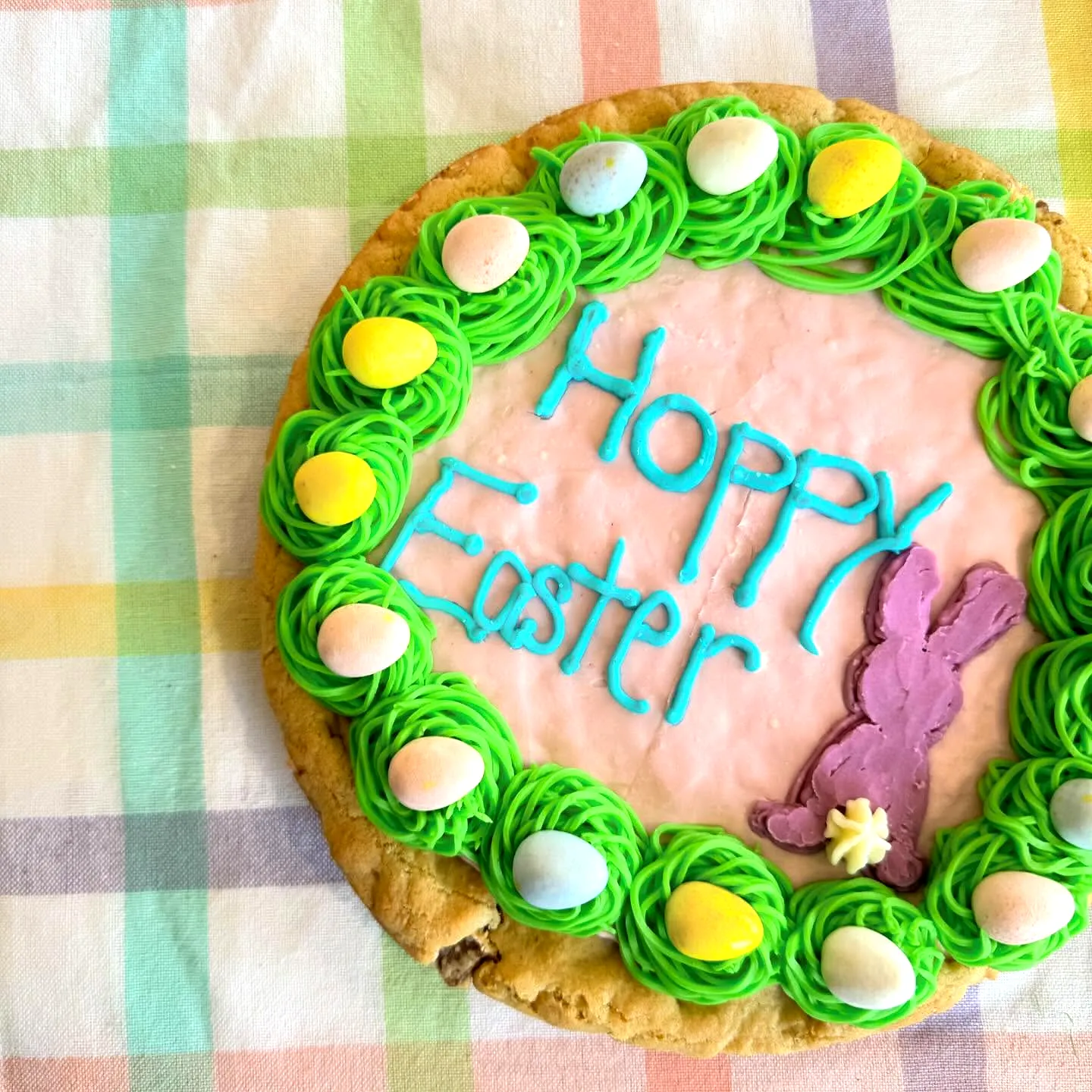 Adorable Easter Cookie Cake with Colorful Decorations and Fun Frosting Design