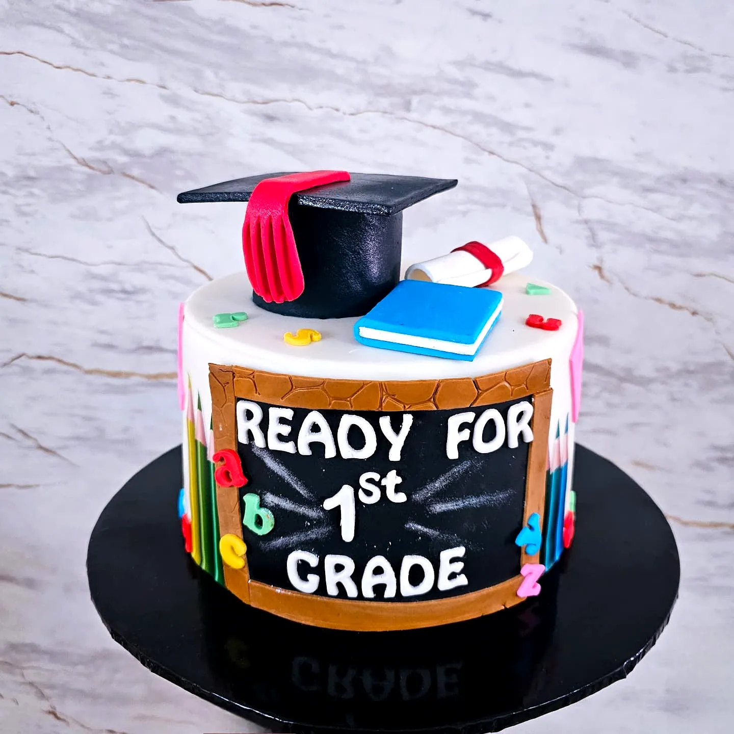Adorable Kindergarten Graduation Cake with Colorful Decorations and Fun Accents