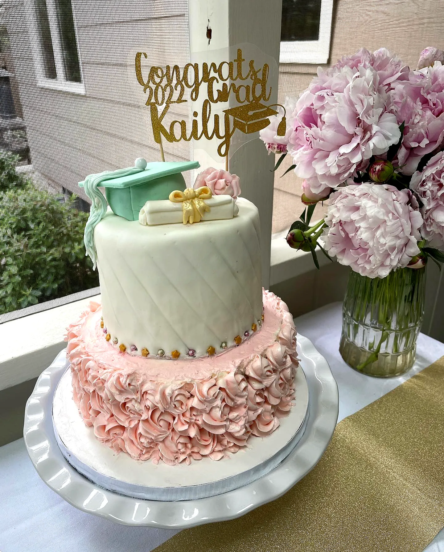 Adorable Pink Graduation Cake Design with Ruffles and Elegant Accents