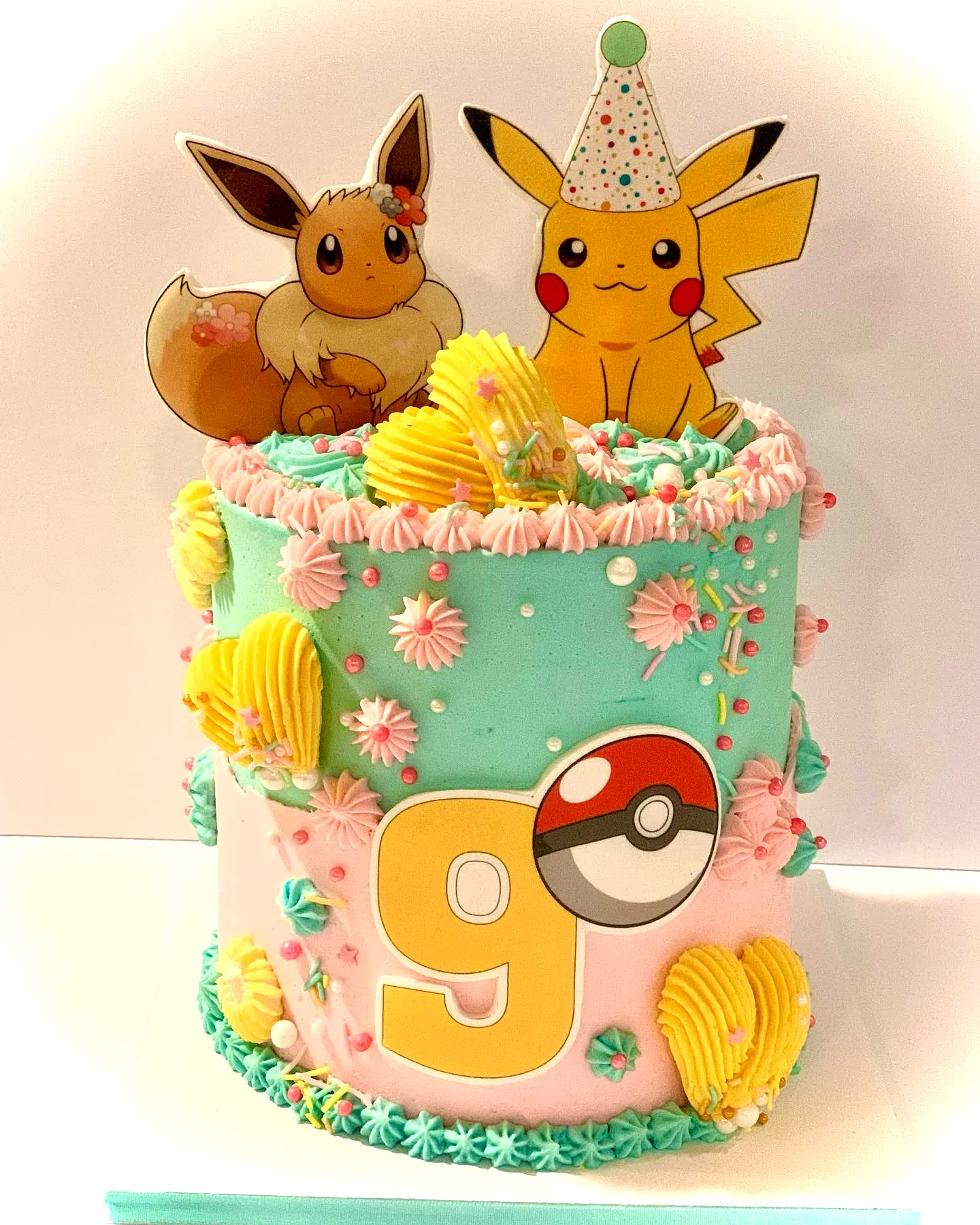 Adorable Pokemon Birthday Cake Design with Colorful Decorations and Toppers