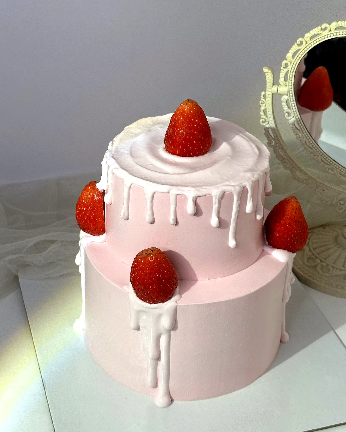 Adorable strawberry birthday cake with playful design and fresh fruity topping
