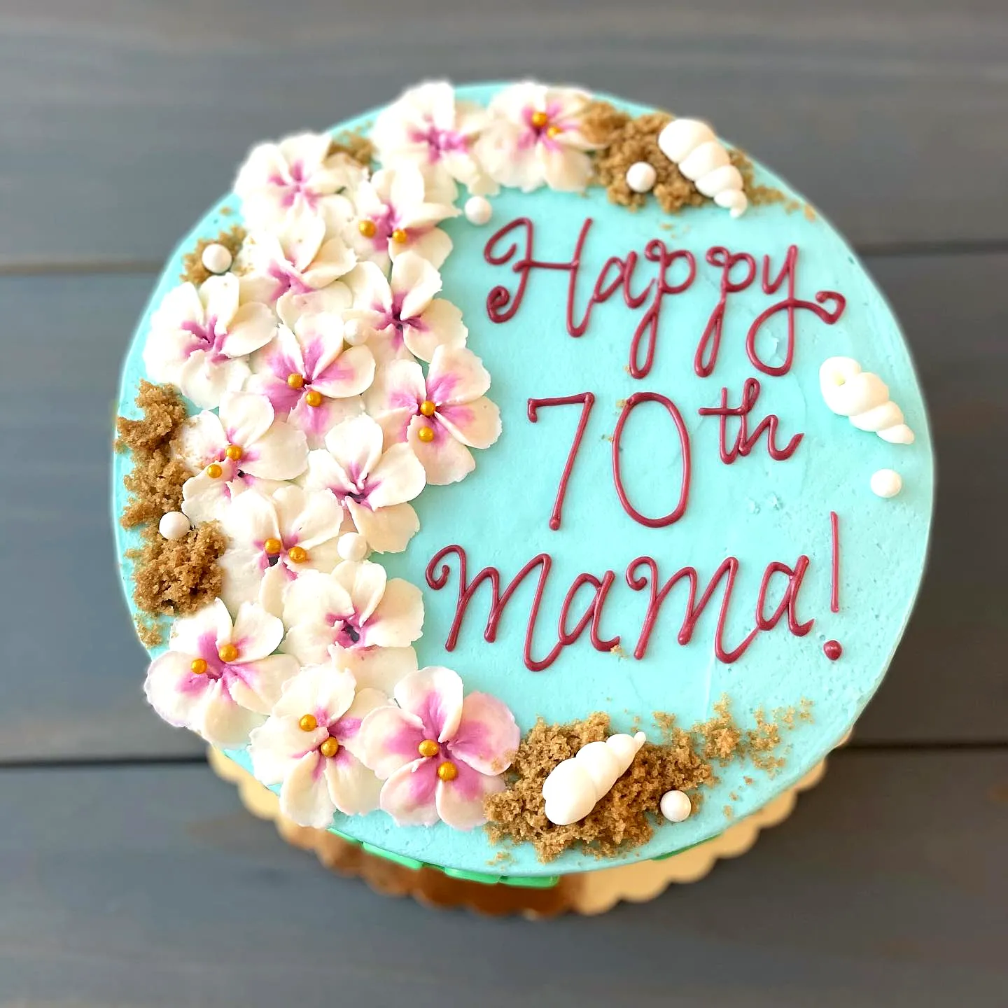 Adorable Tropical 70th Birthday Cake Decorated with Aqua Buttercream and Flowers