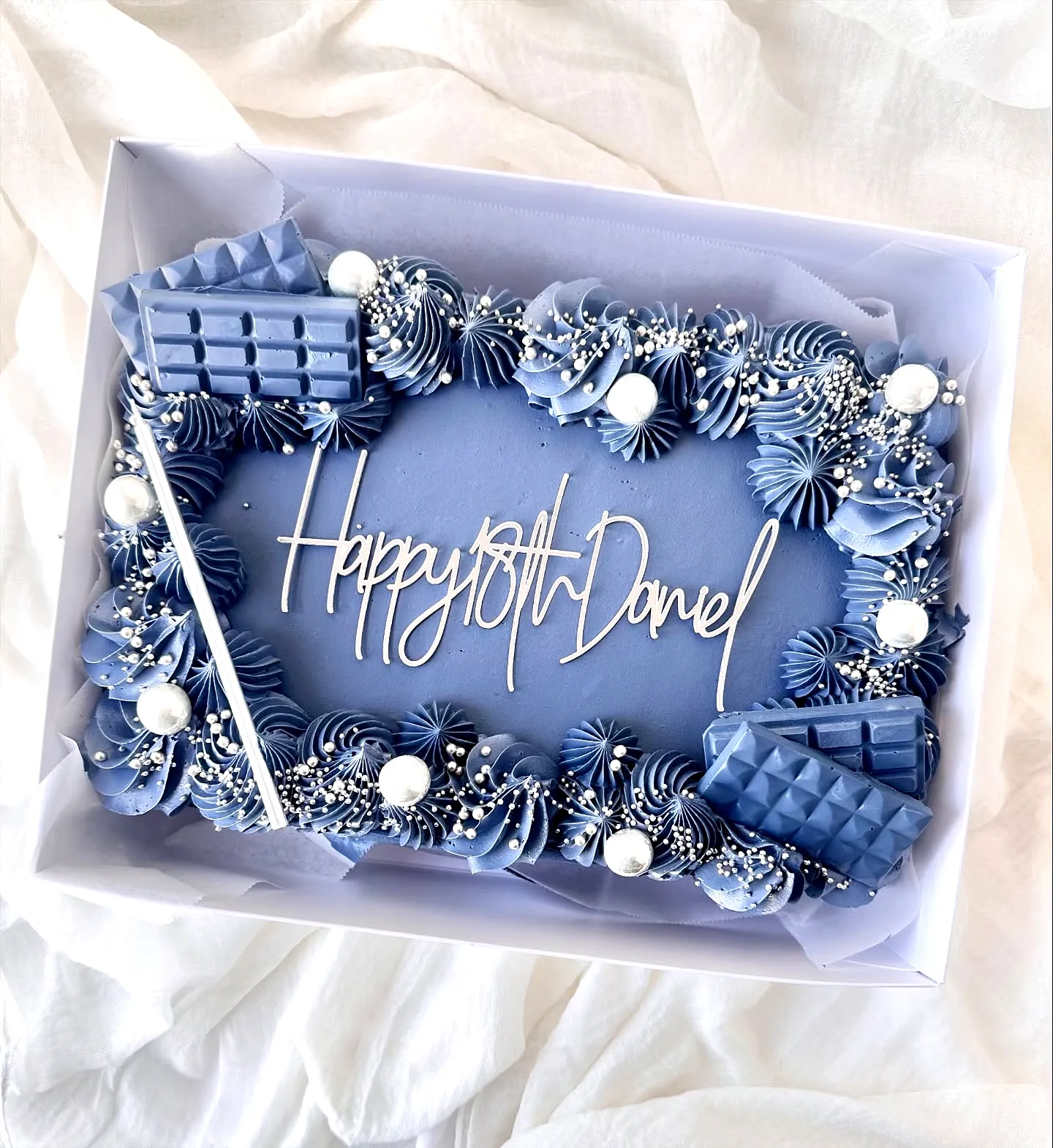 Charming Birthday Cake for Men with Light Blue Frosting and Fun Decor