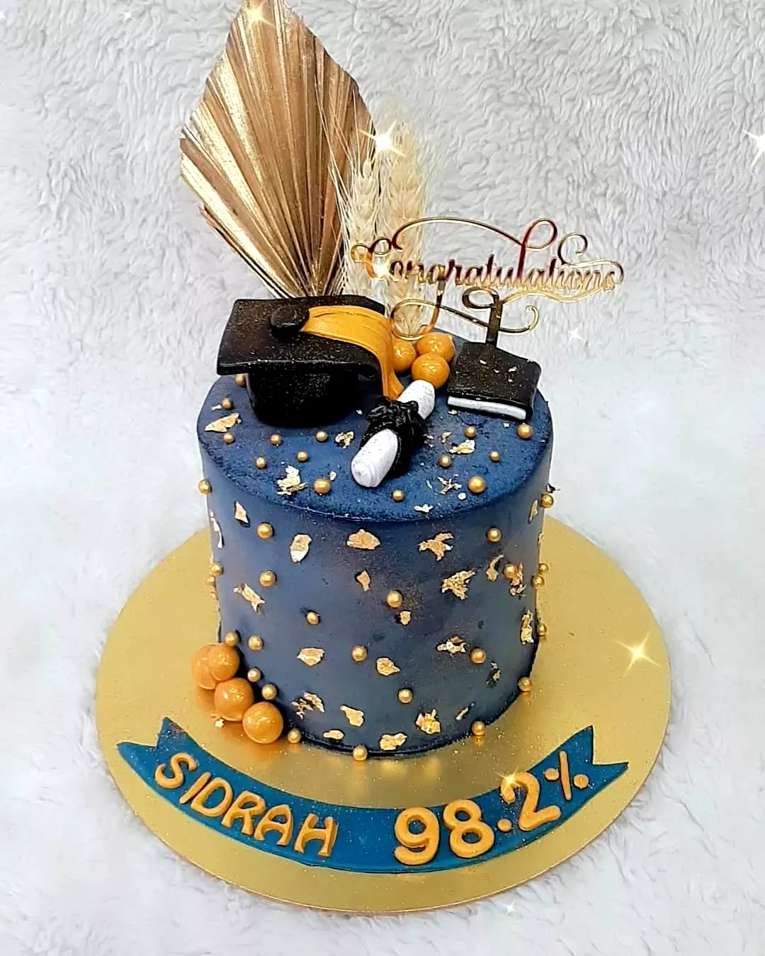 Charming Blue and Gold Graduation Cake Design for a Celebration