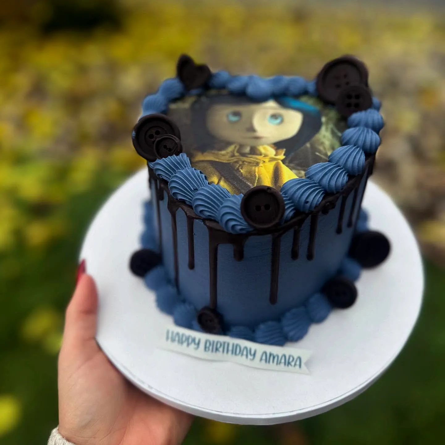 Charming Coraline Birthday Cake Design with Blue Buttercream and Whimsical Touches