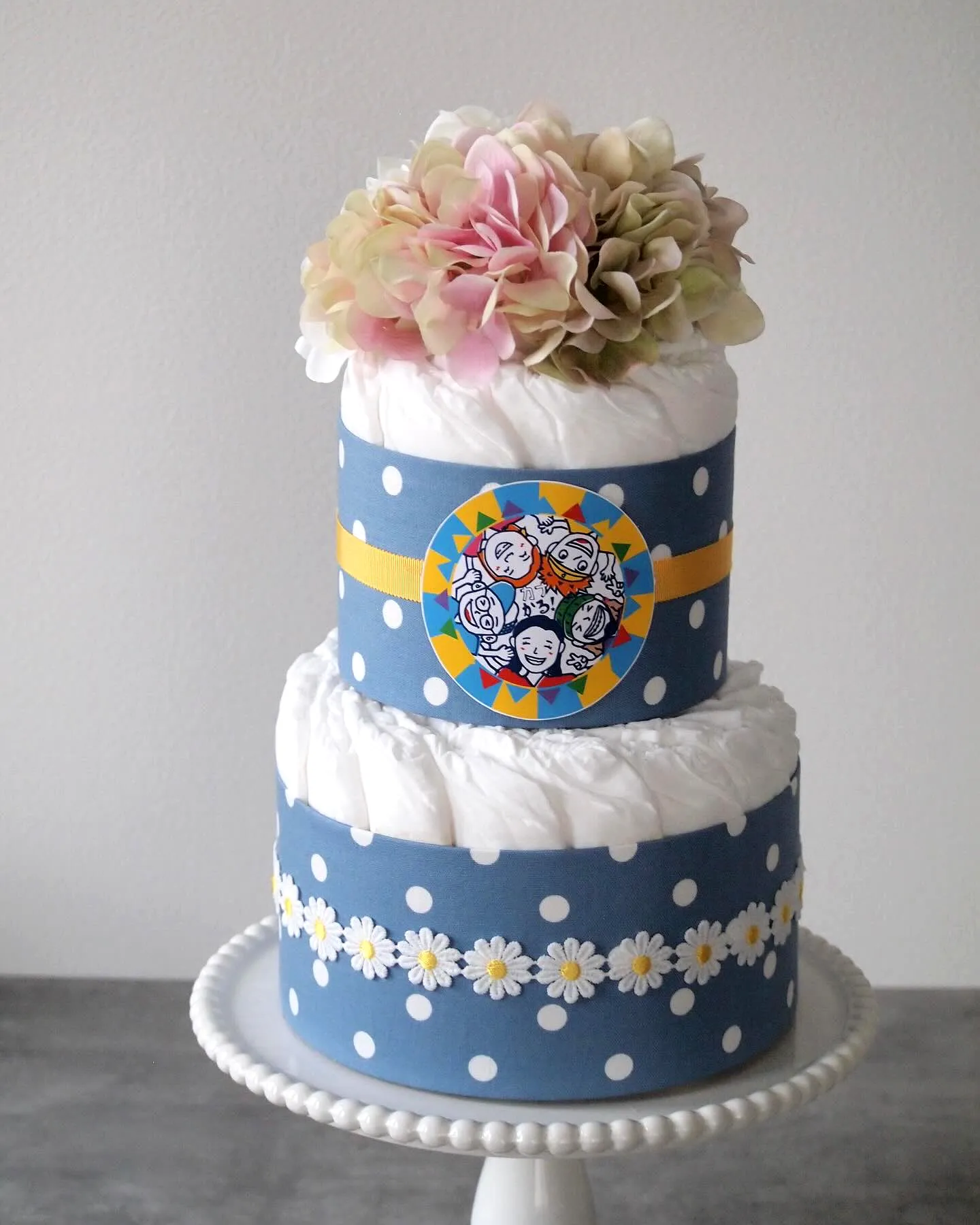 Charming Diaper Cake Design in Soft Blue with Whimsical Decorations