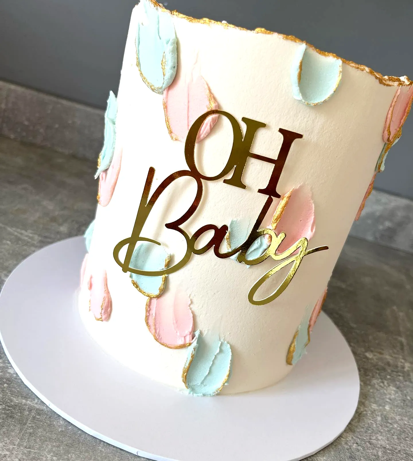Charming Gender Reveal Cake Design with Trendy Pastel Accents and Gold Trim