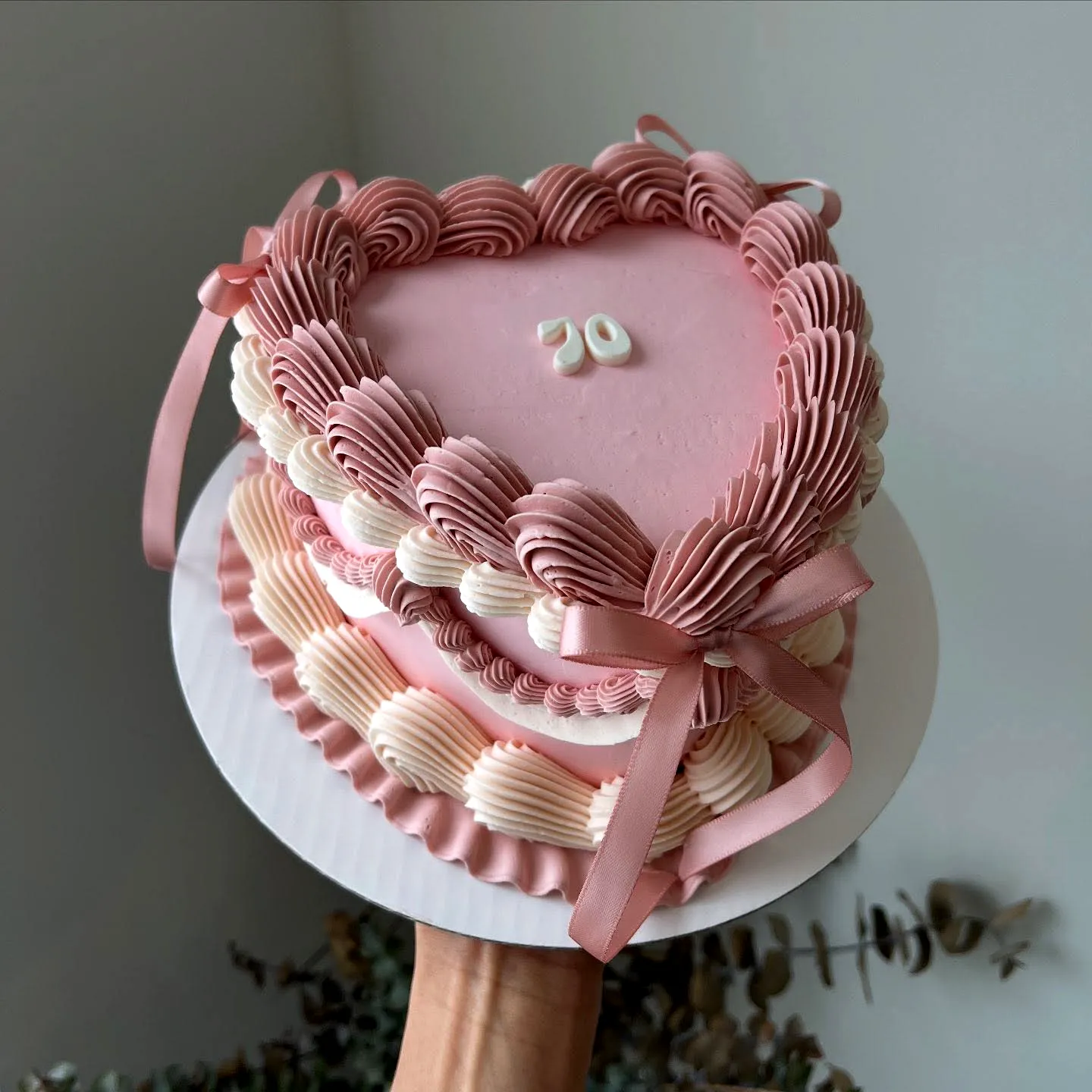 Charming Heart-Shaped 70th Birthday Cake Design in Pastel Pink