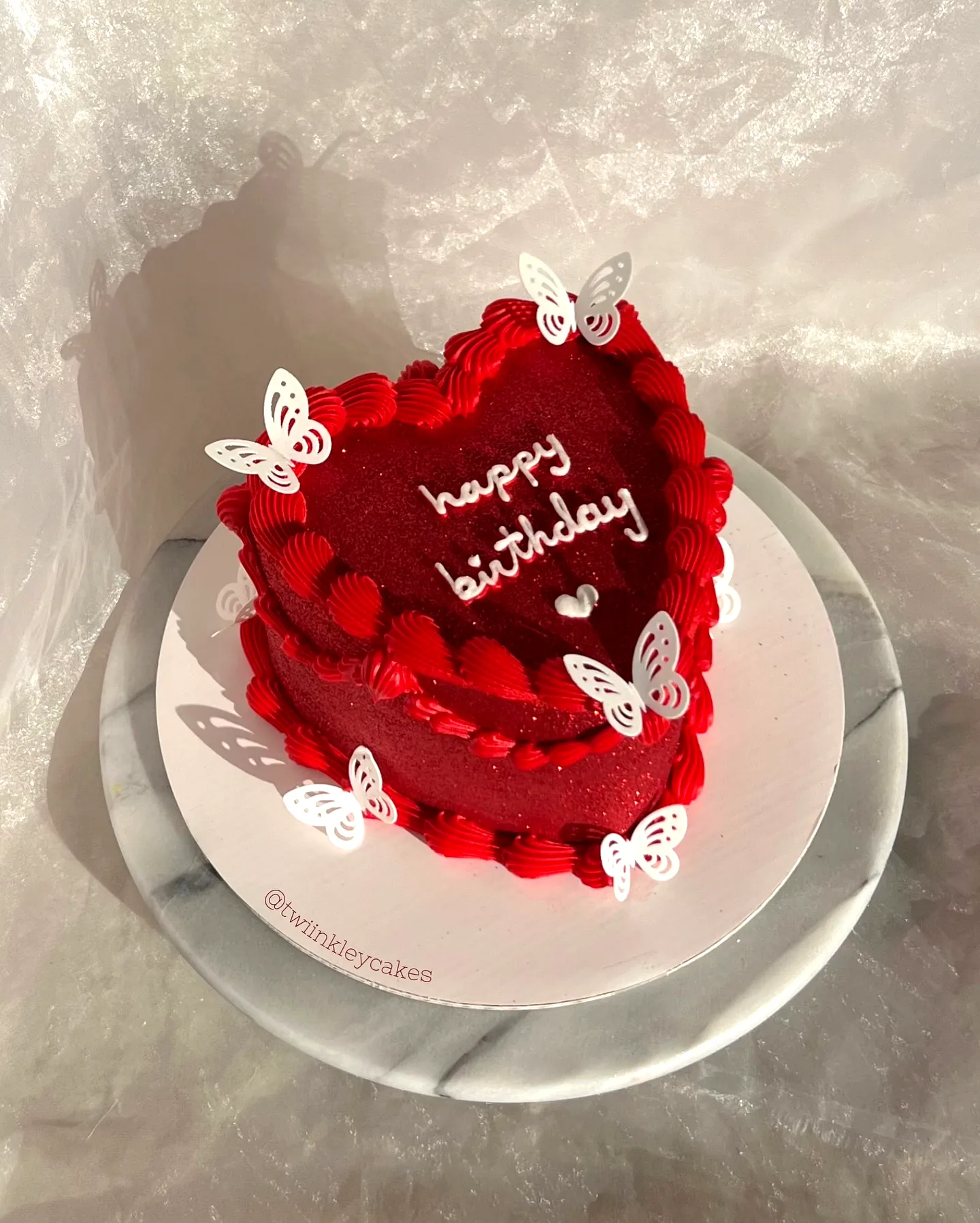 Charming Heart-Shaped Red Birthday Cake Design with Rosettes and Butterflies