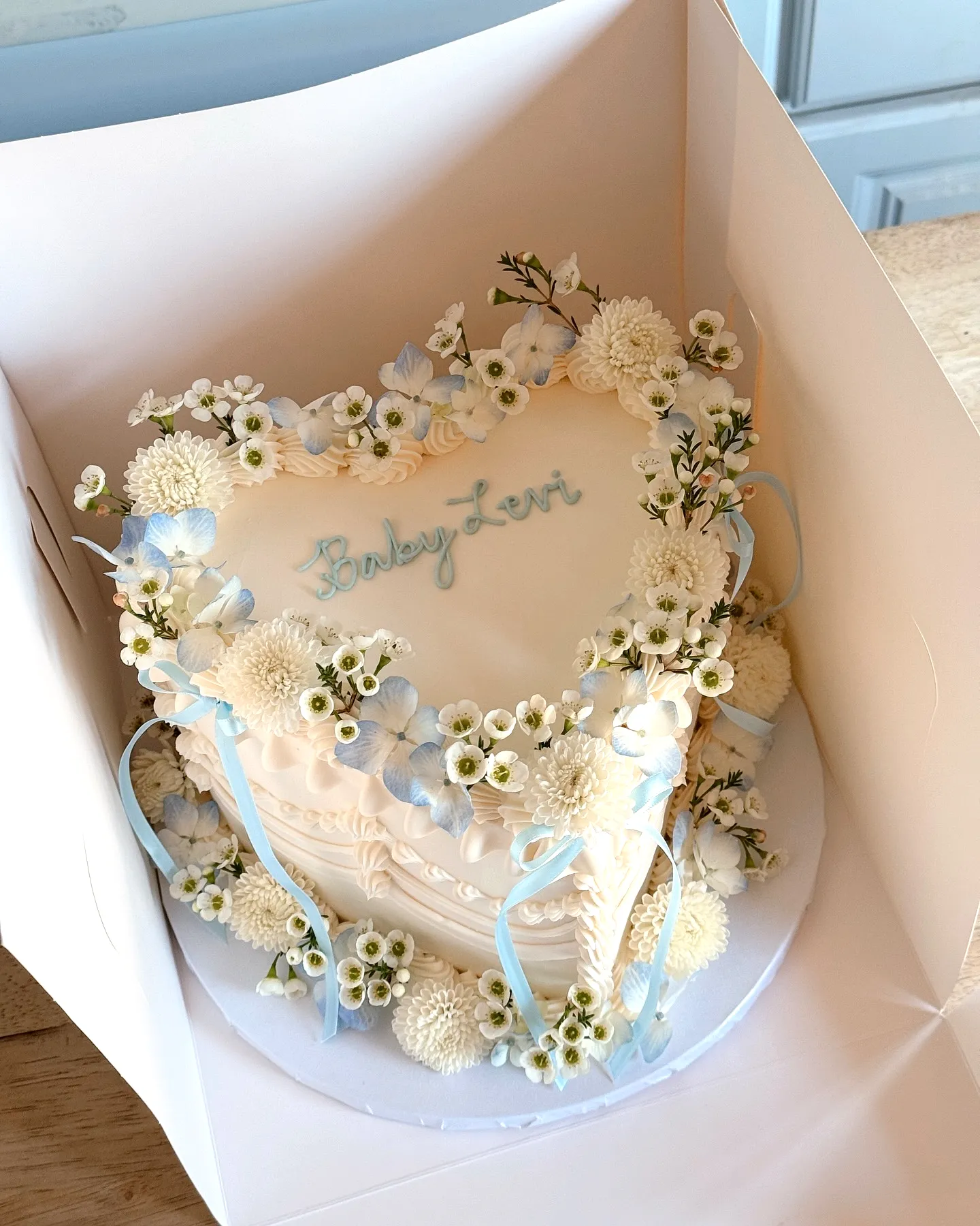 Charming Off-White Heart-Shaped Baby Shower Cake Design with Elegant Accents