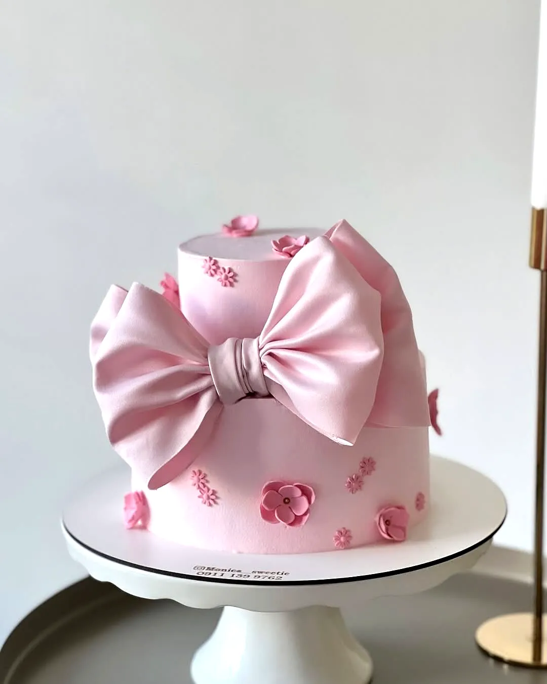 Charming Pink Birthday Cake Design with Elegant Floral Decorations and Bow
