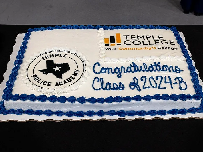 Charming Police Academy Graduation Cake in Classic White and Blue Design