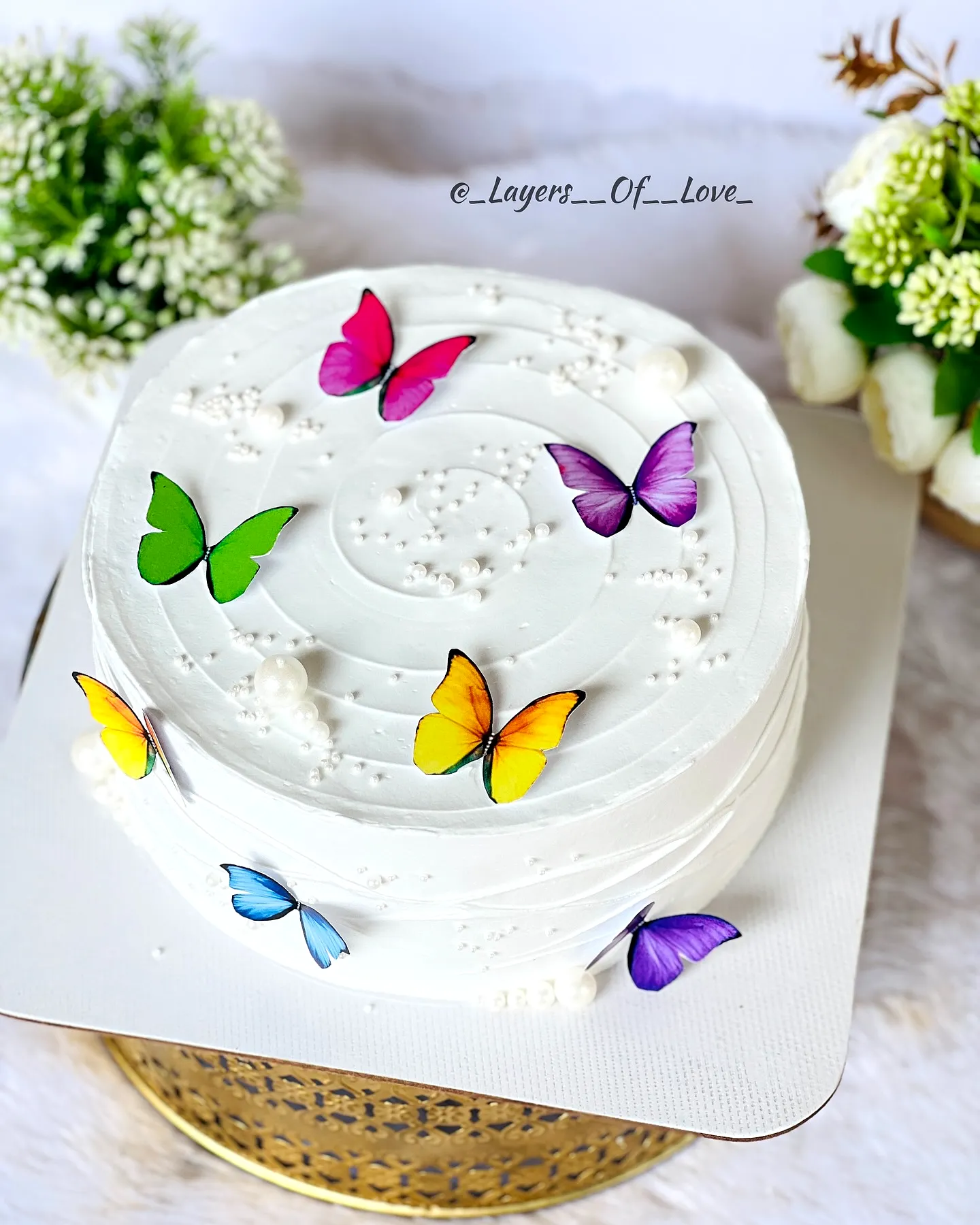 Charming Simple Birthday Cake Design with Colorful Butterflies and Smooth Frosting