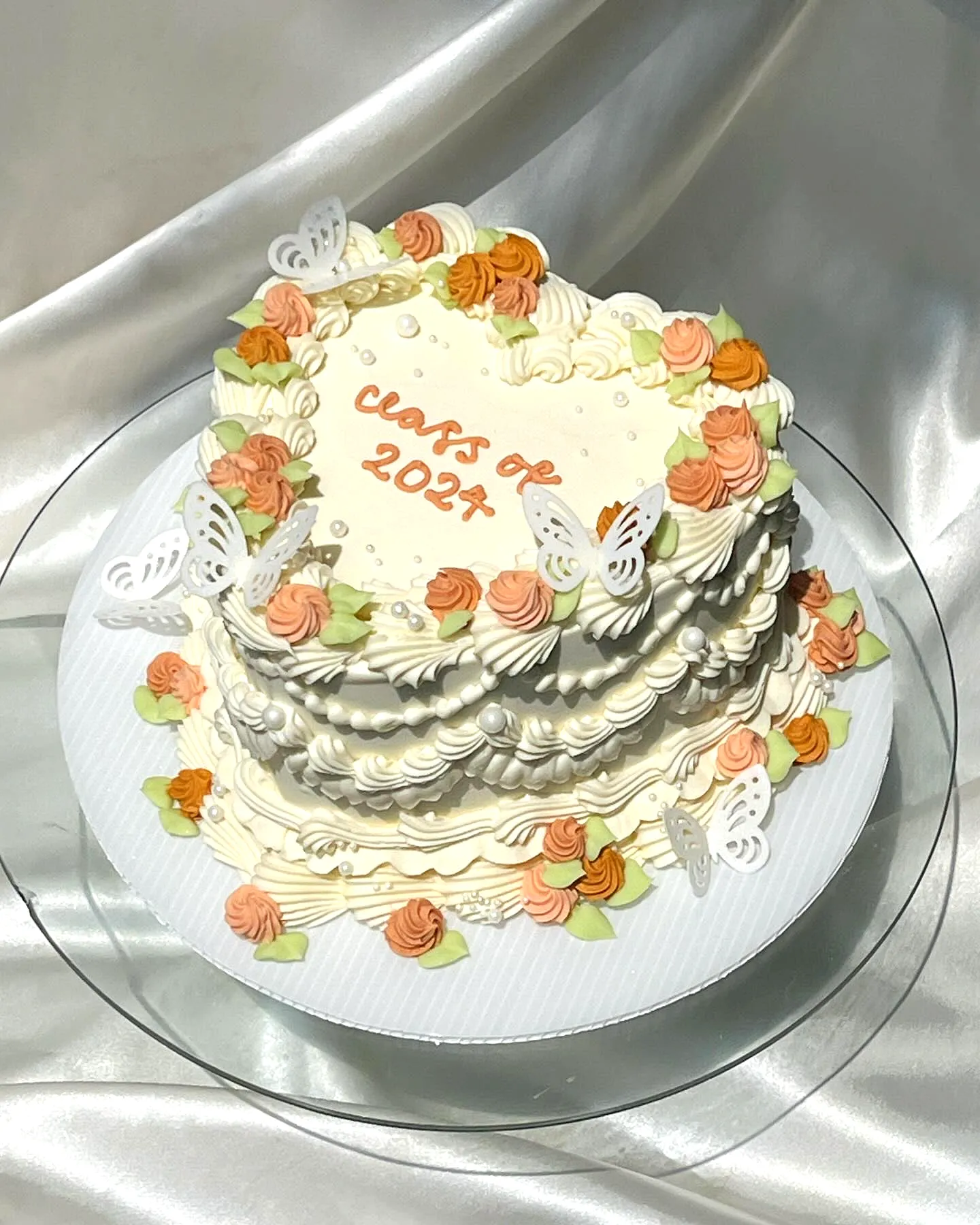 Charming Simple Graduation Cake with Heart-Shaped Elegance and Delicate Details