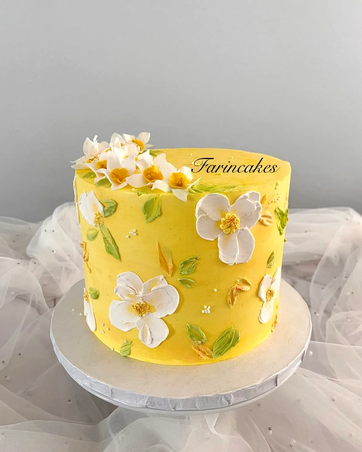 Charming Yellow Birthday Cake Design with Buttercream and Floral Accents