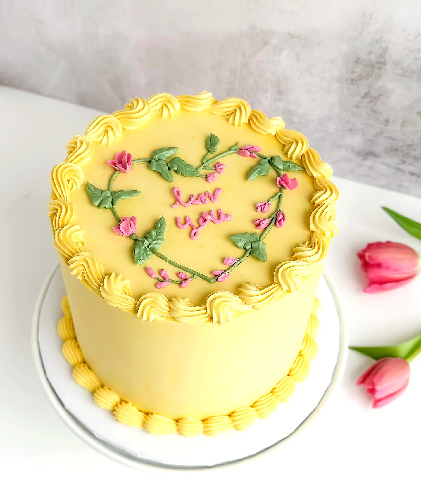 Charming Yellow Birthday Cake Design with Floral Decorations and Ruffle Texture