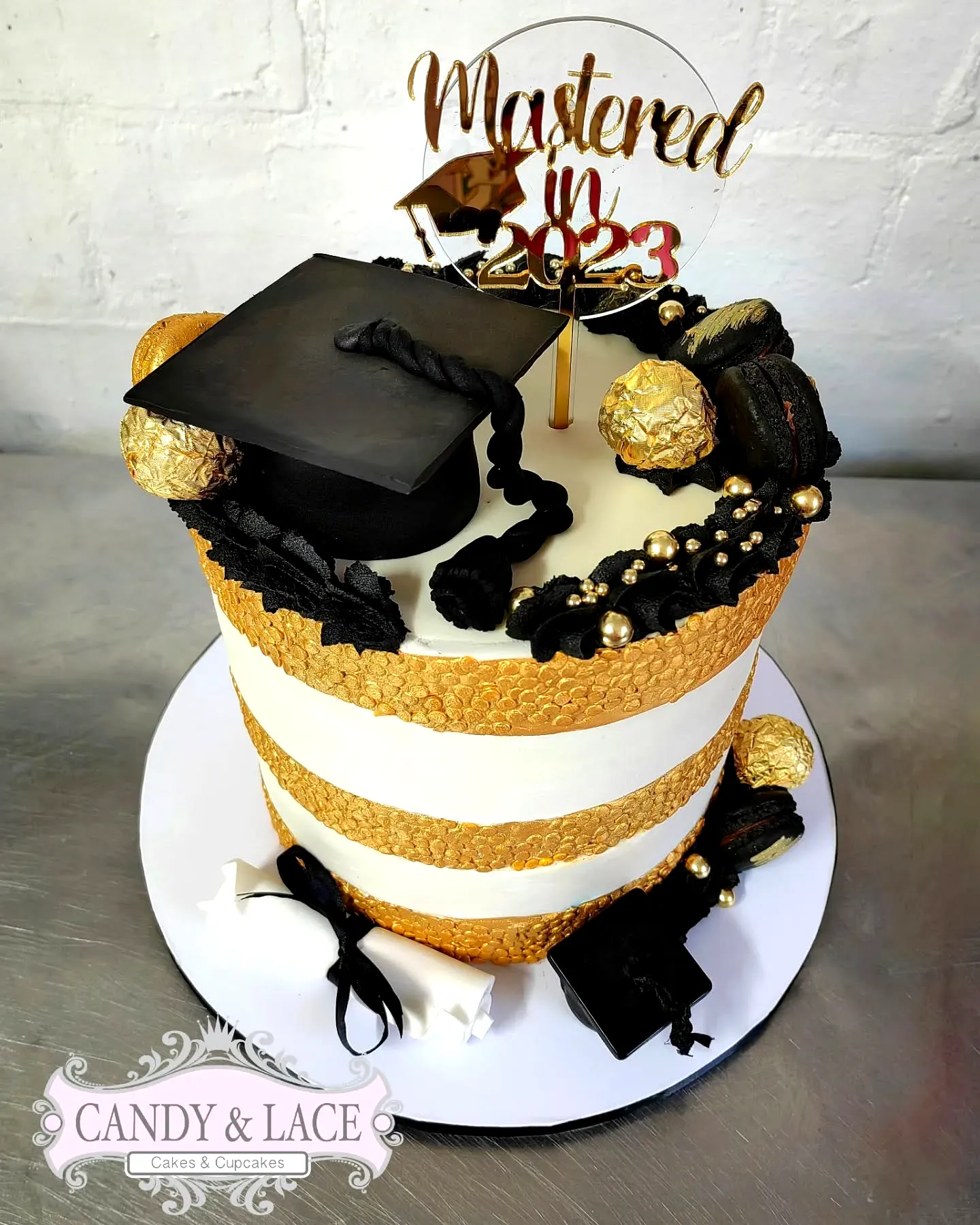 Chic black and gold graduation cake for a modern celebration