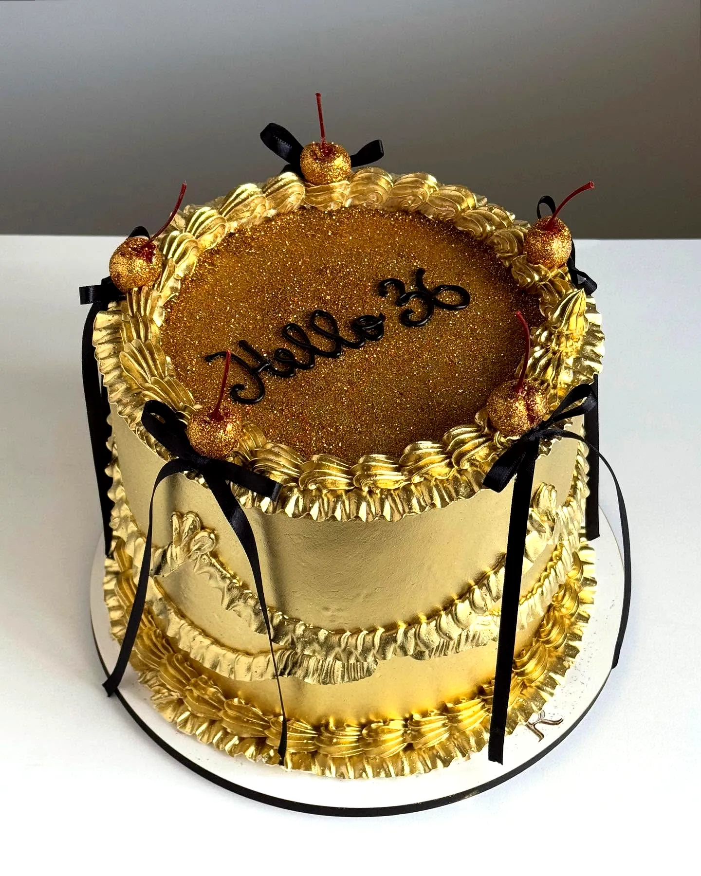 Chic Golden Birthday Cake with Edible Glitter and Festive Decorations