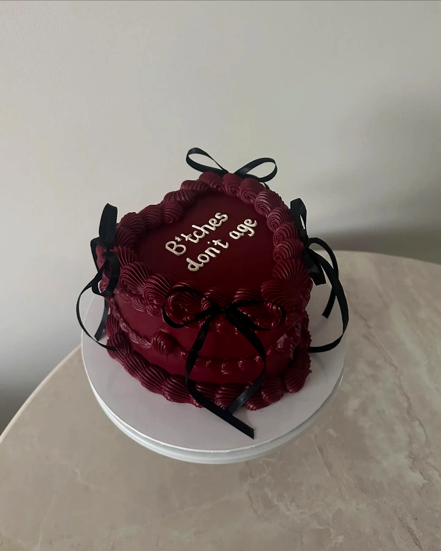 Chic red velvet cake design with playful decorations for womens birthdays