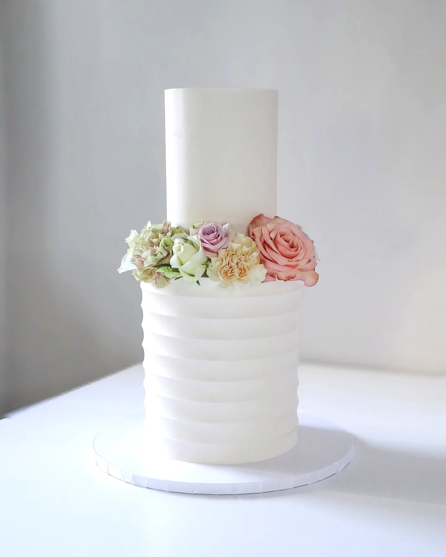 Chic wedding shower cake with modern design and pastel floral accents