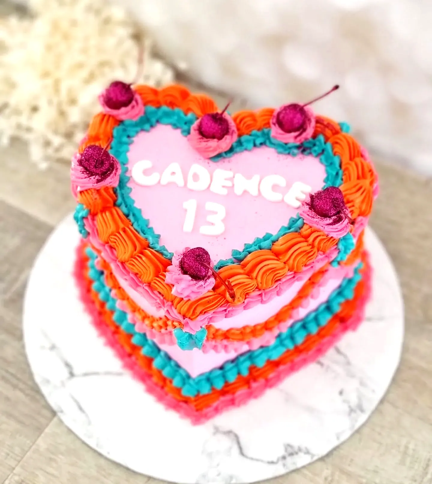 Colorful 13th Birthday Cake Design Featuring Playful Heart Shape and Buttercream