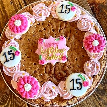 Colorful 15th Birthday Cake with Vibrant Flowers and Personalized Touch
