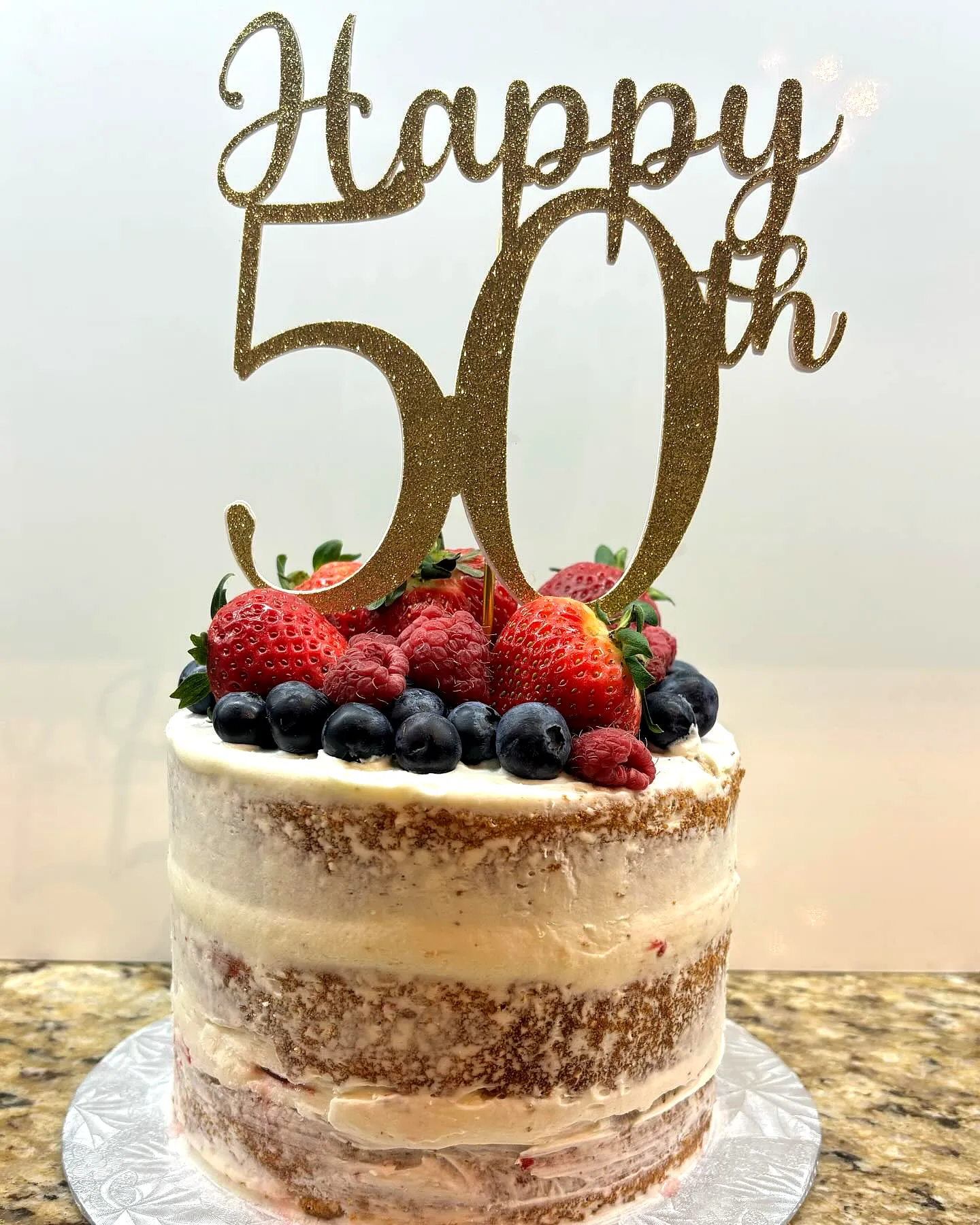 Colorful 50th Birthday Cake for Women with Fresh Berries and Rustic Charm