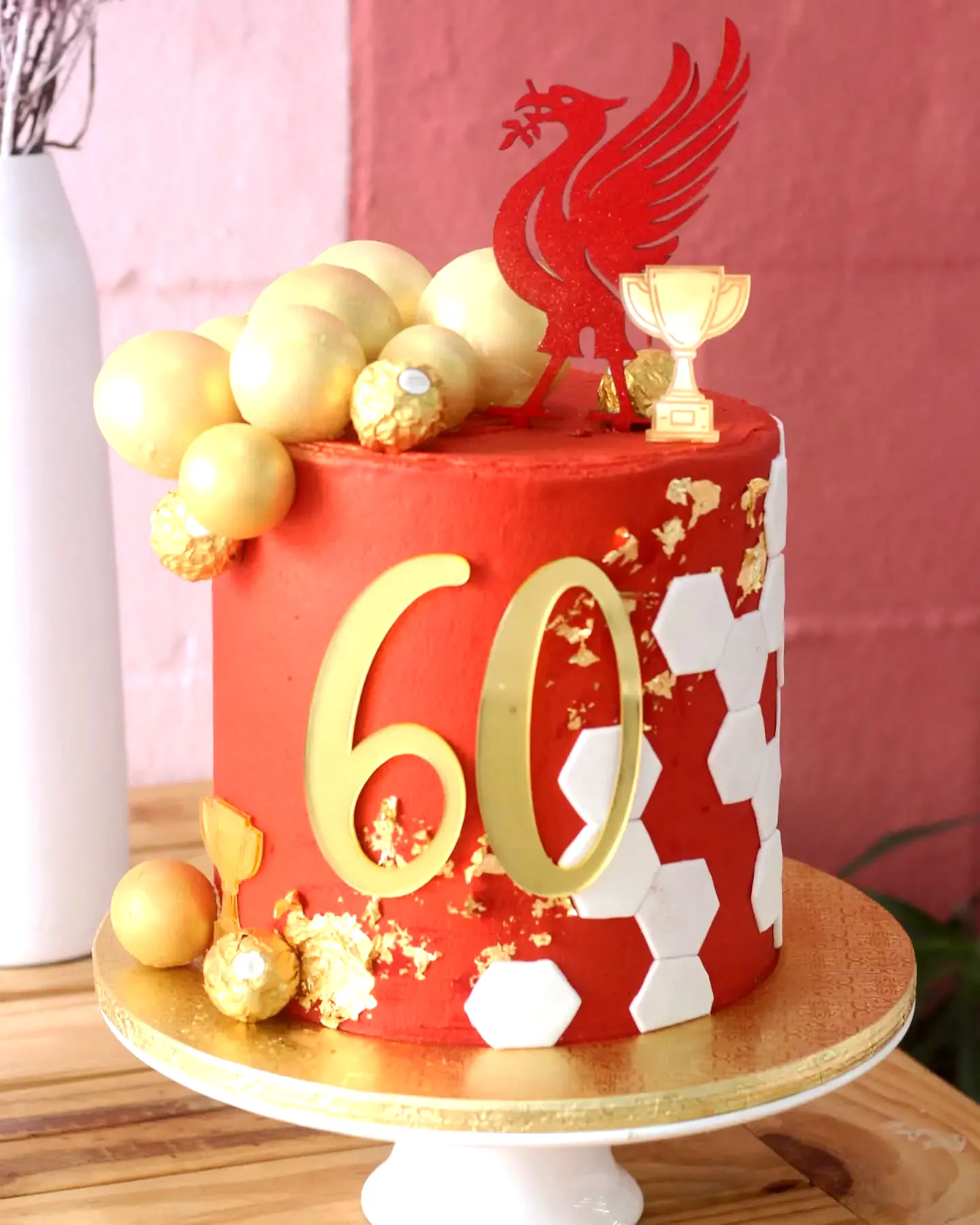 Colorful 60th Birthday Cake for a Man Featuring Gold Accents and Sports Theme