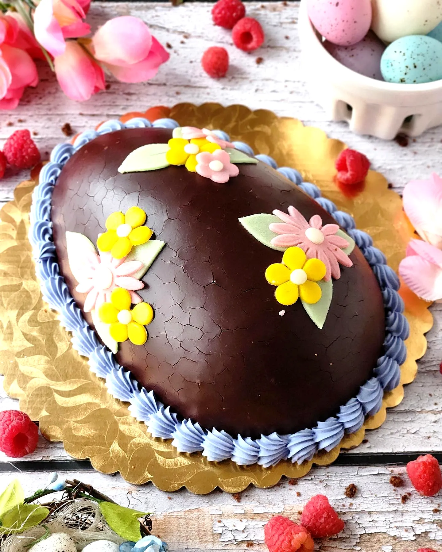 Colorful Easter Egg Cake Design with Pastel Flowers and Raspberries
