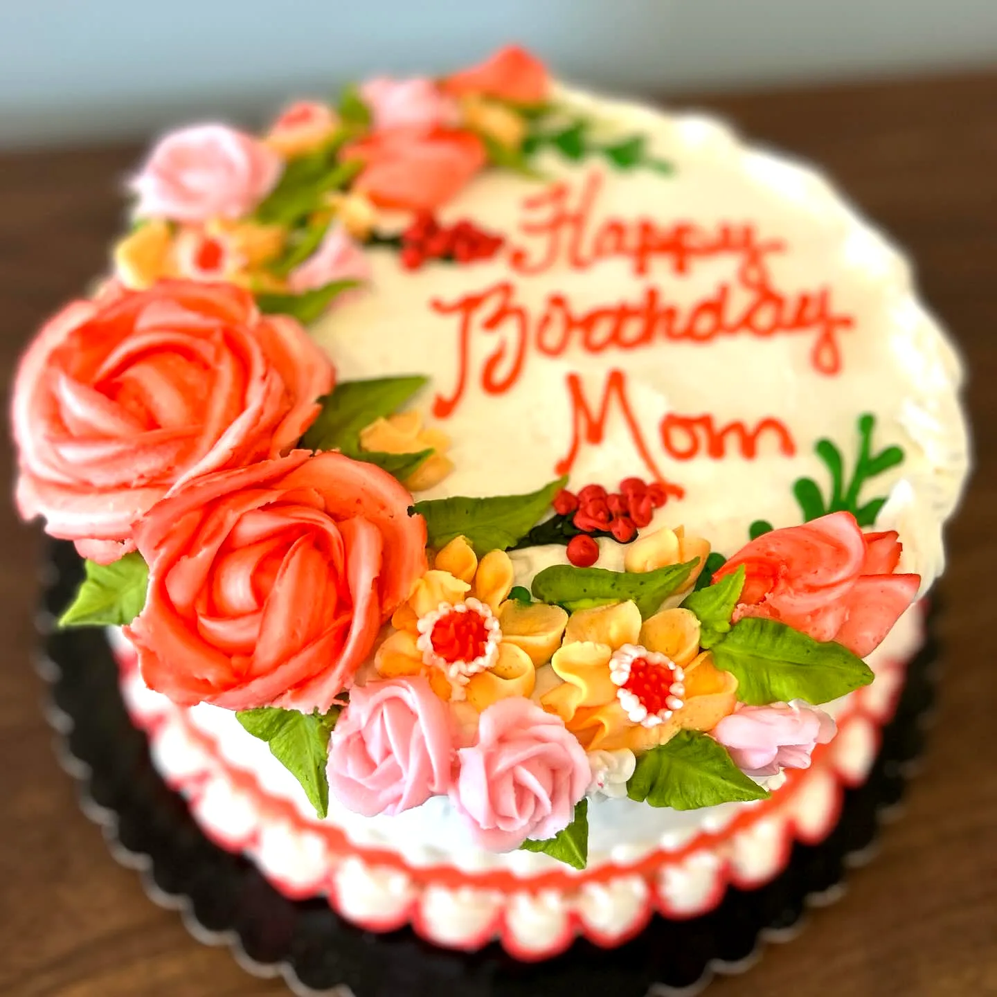 Colorful floral birthday cake for mom with vibrant roses and elegant frosting