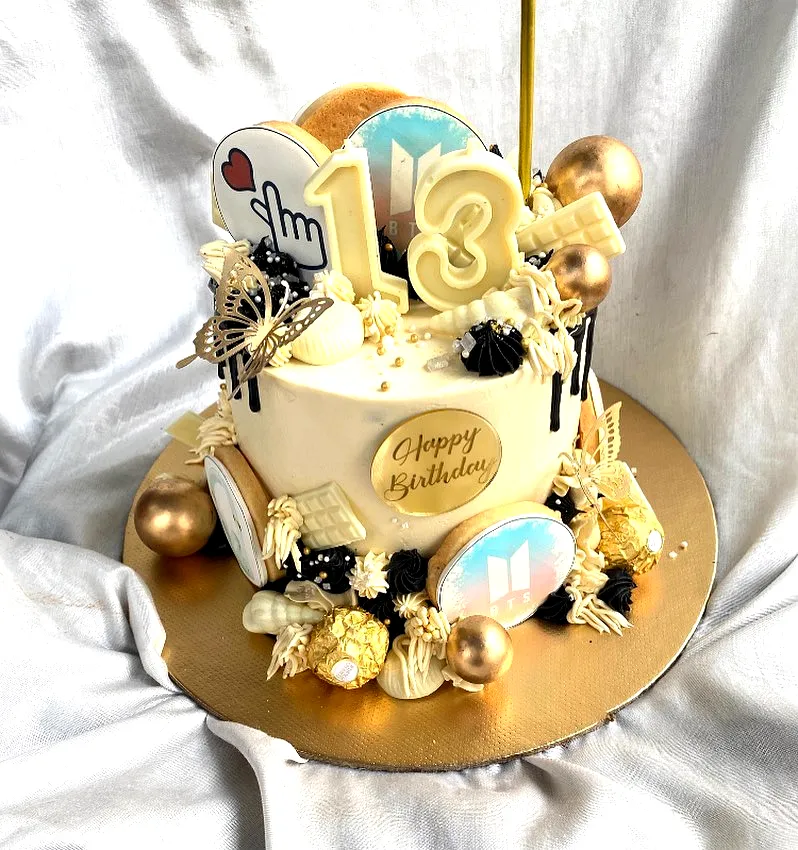 Creative 13th Birthday Cake Design in Gold and Black with Playful Touches