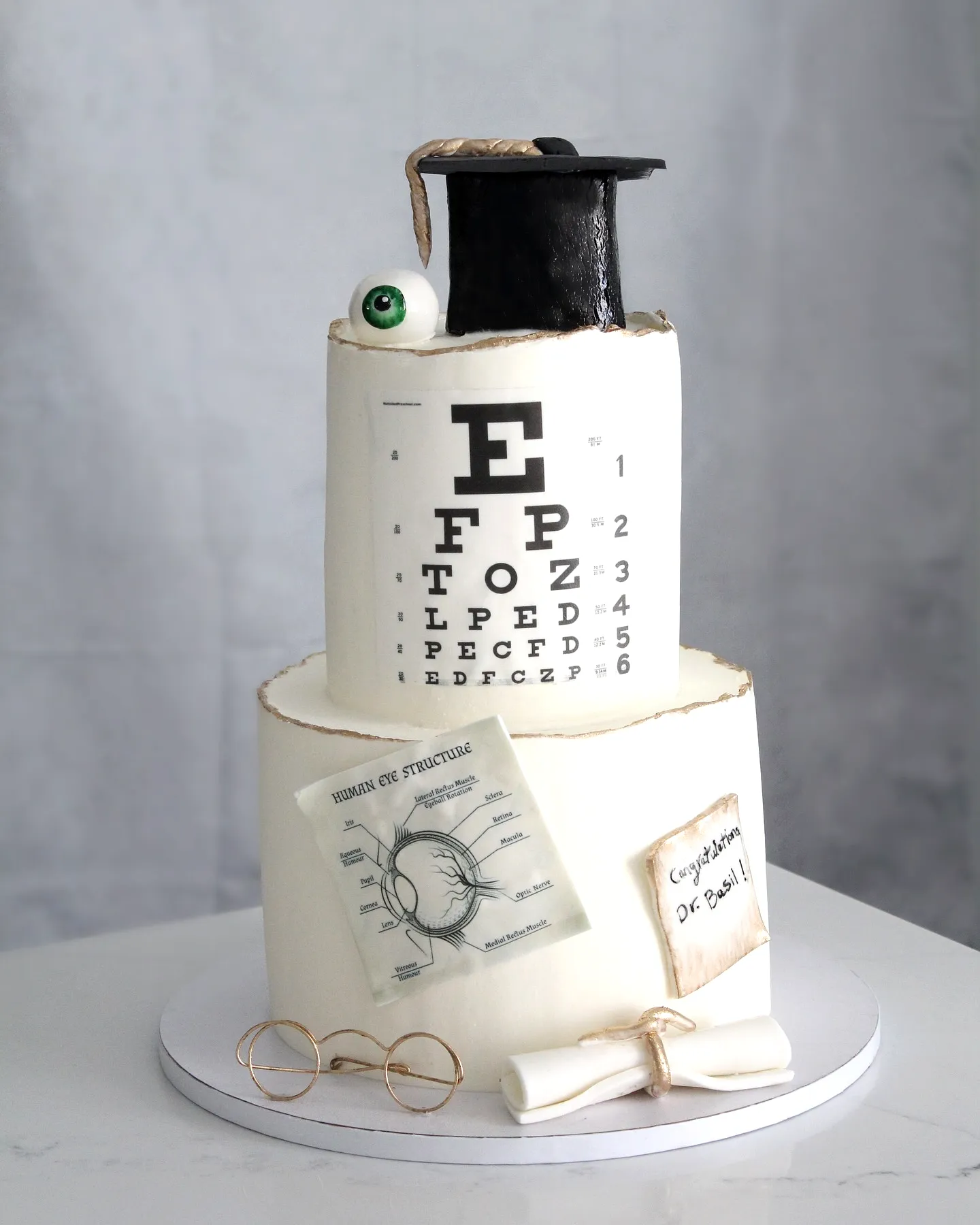 Creative 2 Tier Graduation Cake Design with Academic Themes and Fun Decorations