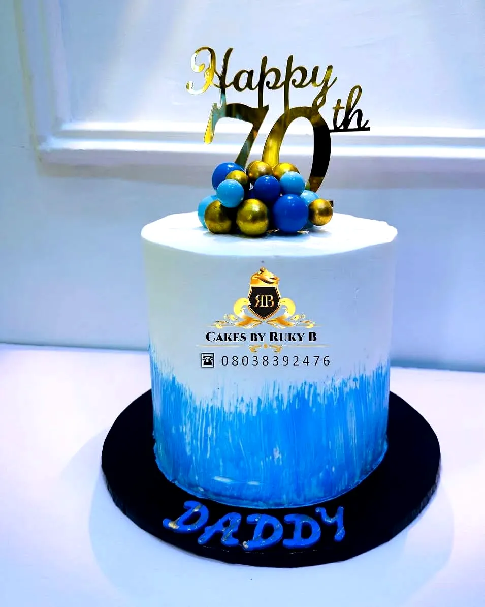 Creative 70th Birthday Cake in Ombre Blue with Gold Accents and Fun Decor