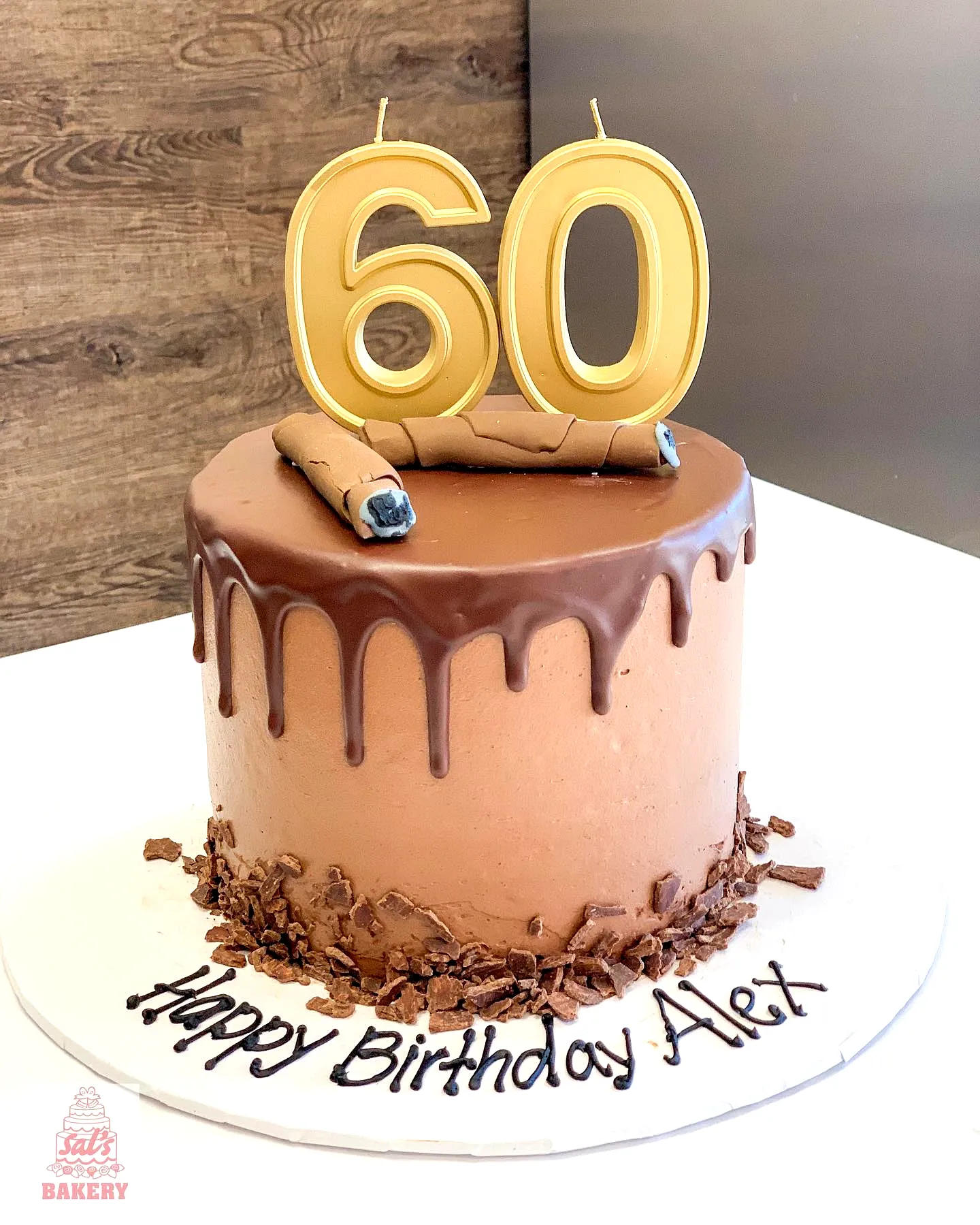 Creative birthday cake for men featuring chocolate ganache and gold candles
