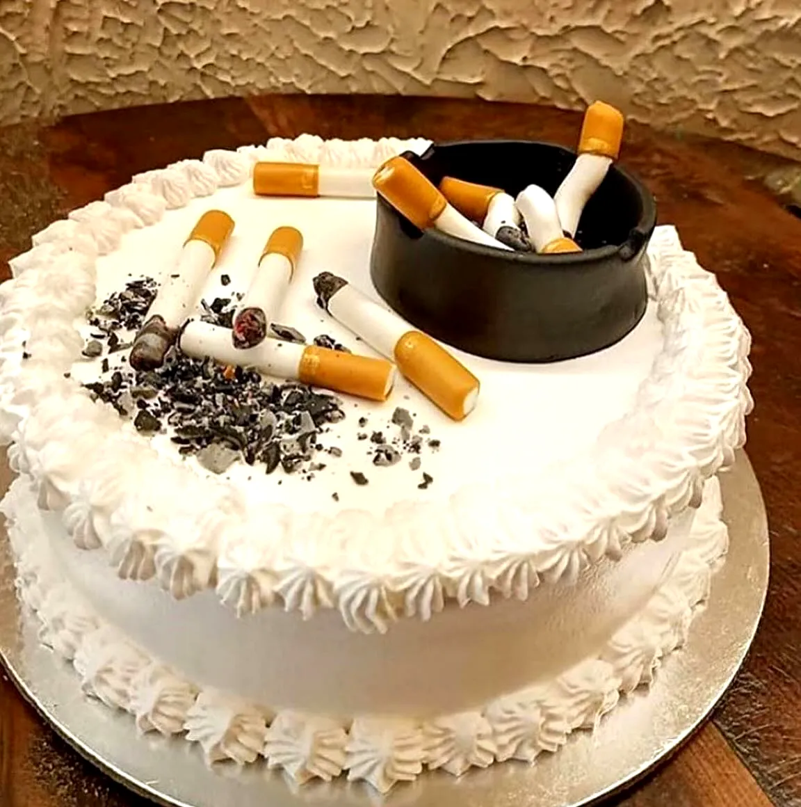 Creative birthday cake for men with a unique cigarette theme and white frosting