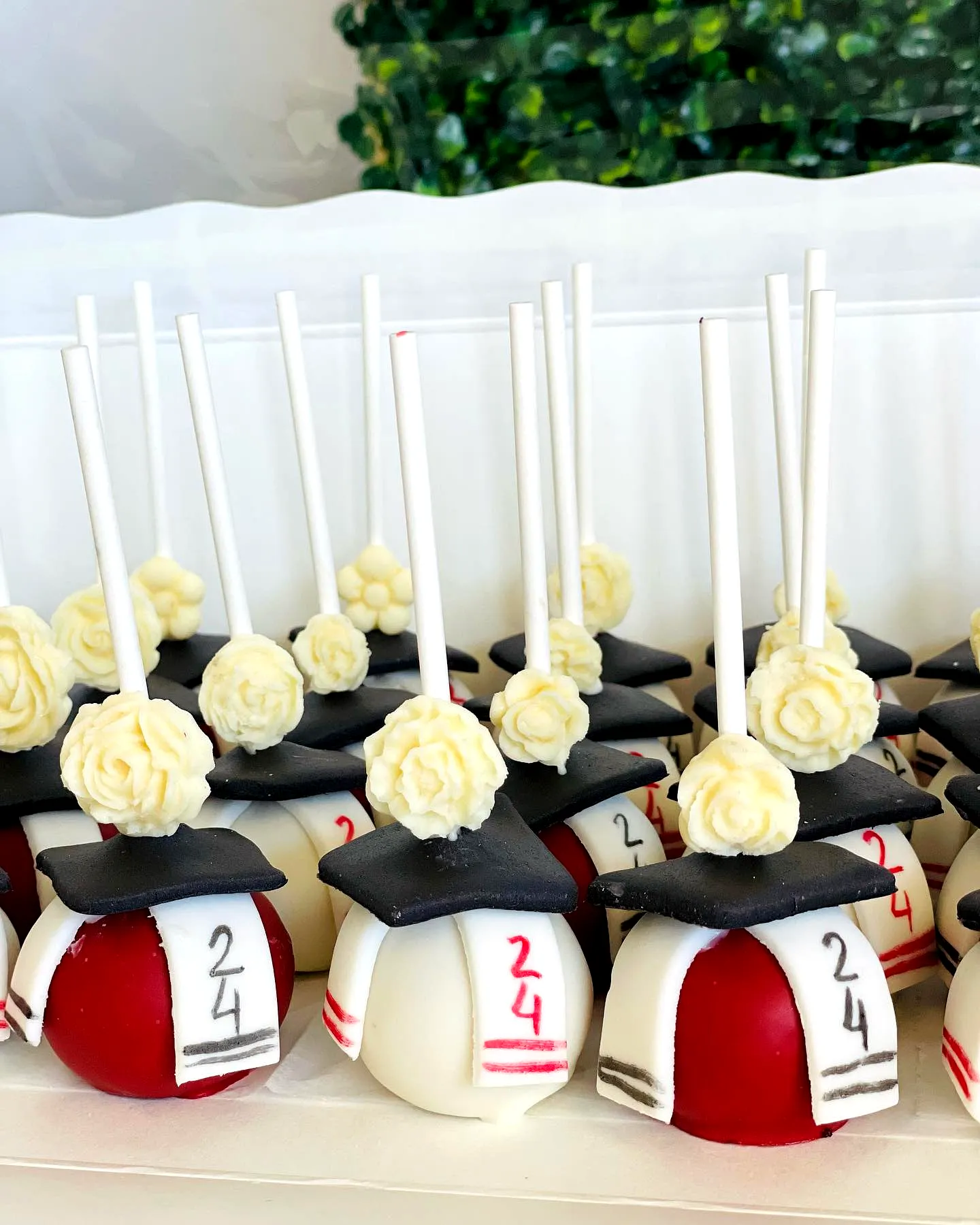 Creative graduation cake pop design with adorable caps and diplomas