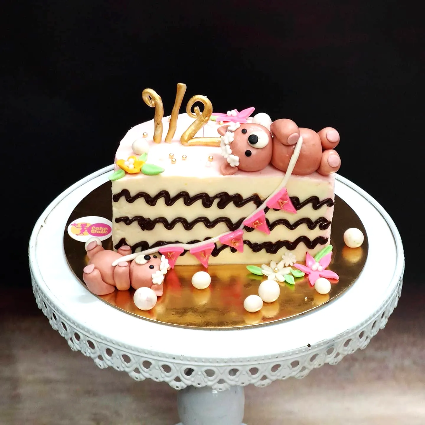 Creative half birthday cake design in playful pink and cream colors