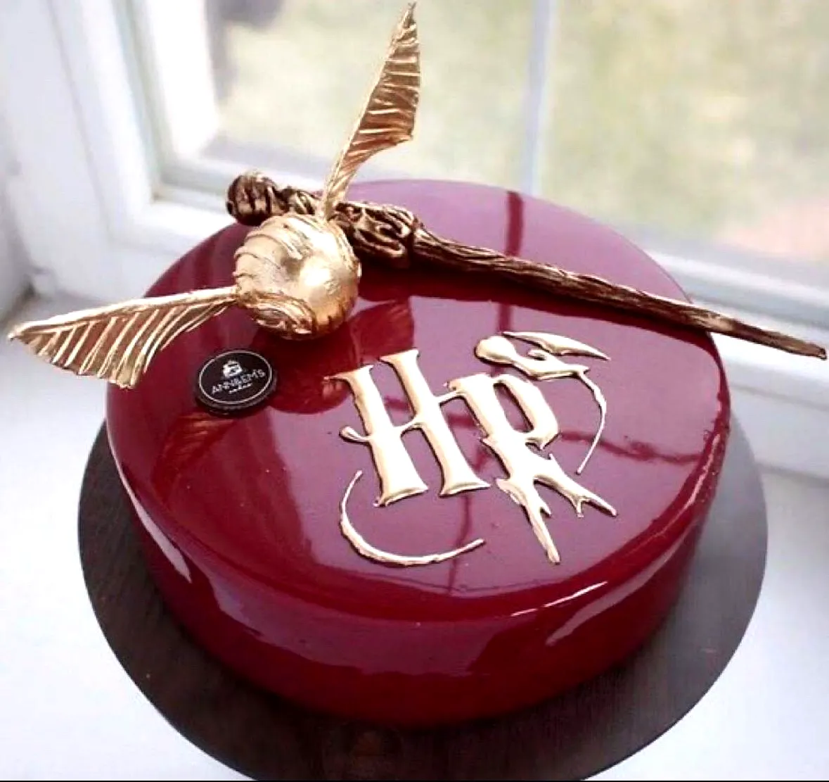 Creative Harry Potter Birthday Cake Design with Golden Snitch and Glossy Finish