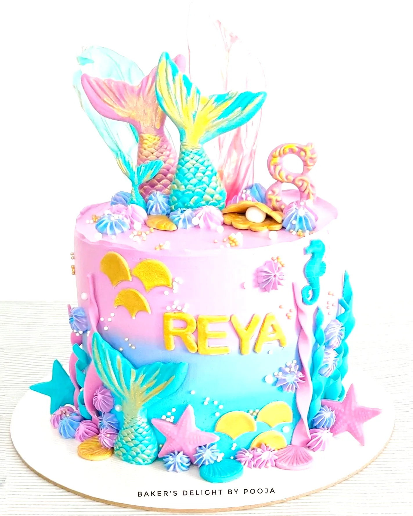 Creative mermaid birthday cake design with colorful decorations and textures