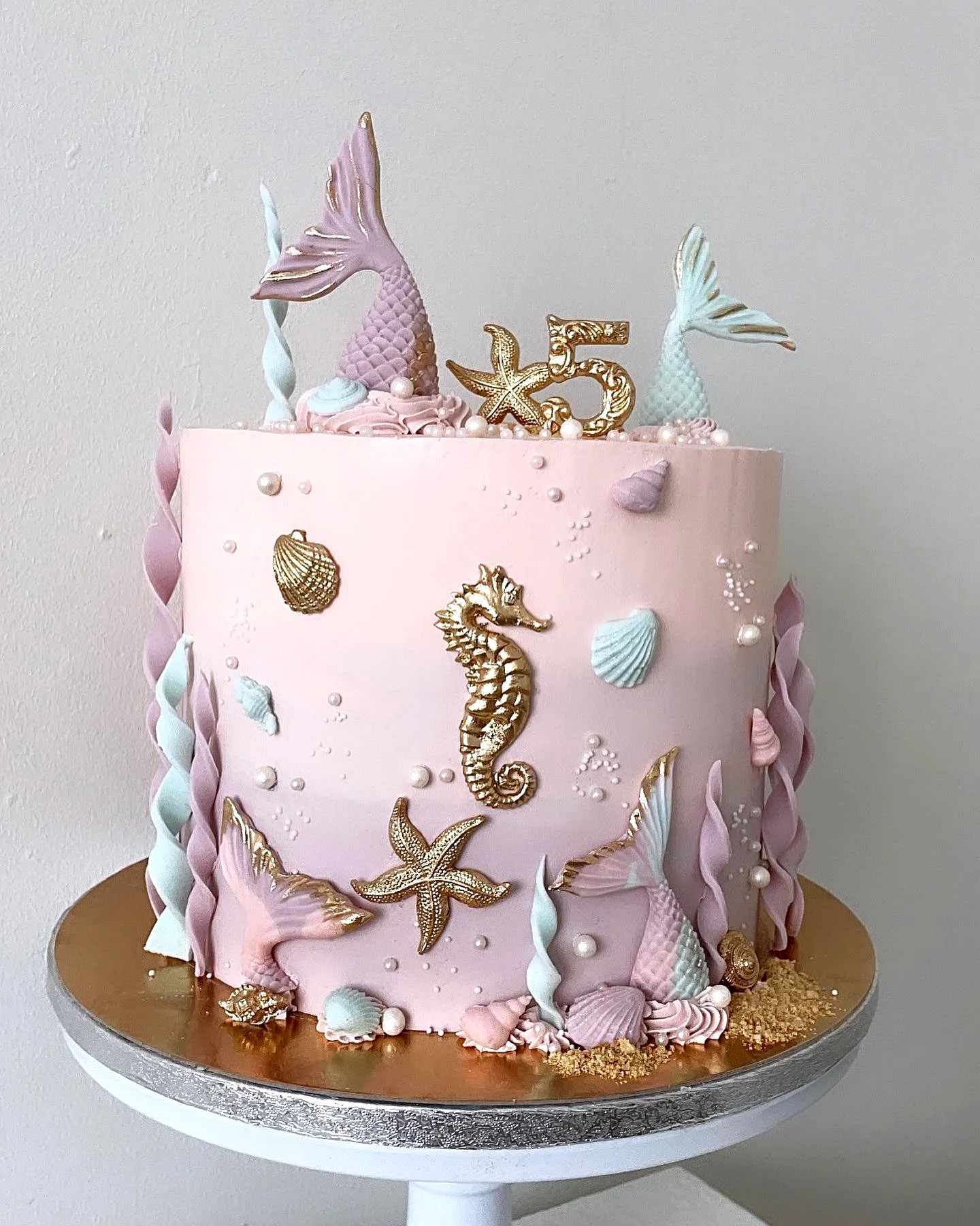 Creative mermaid cake design with whimsical underwater theme and soft pastel colors
