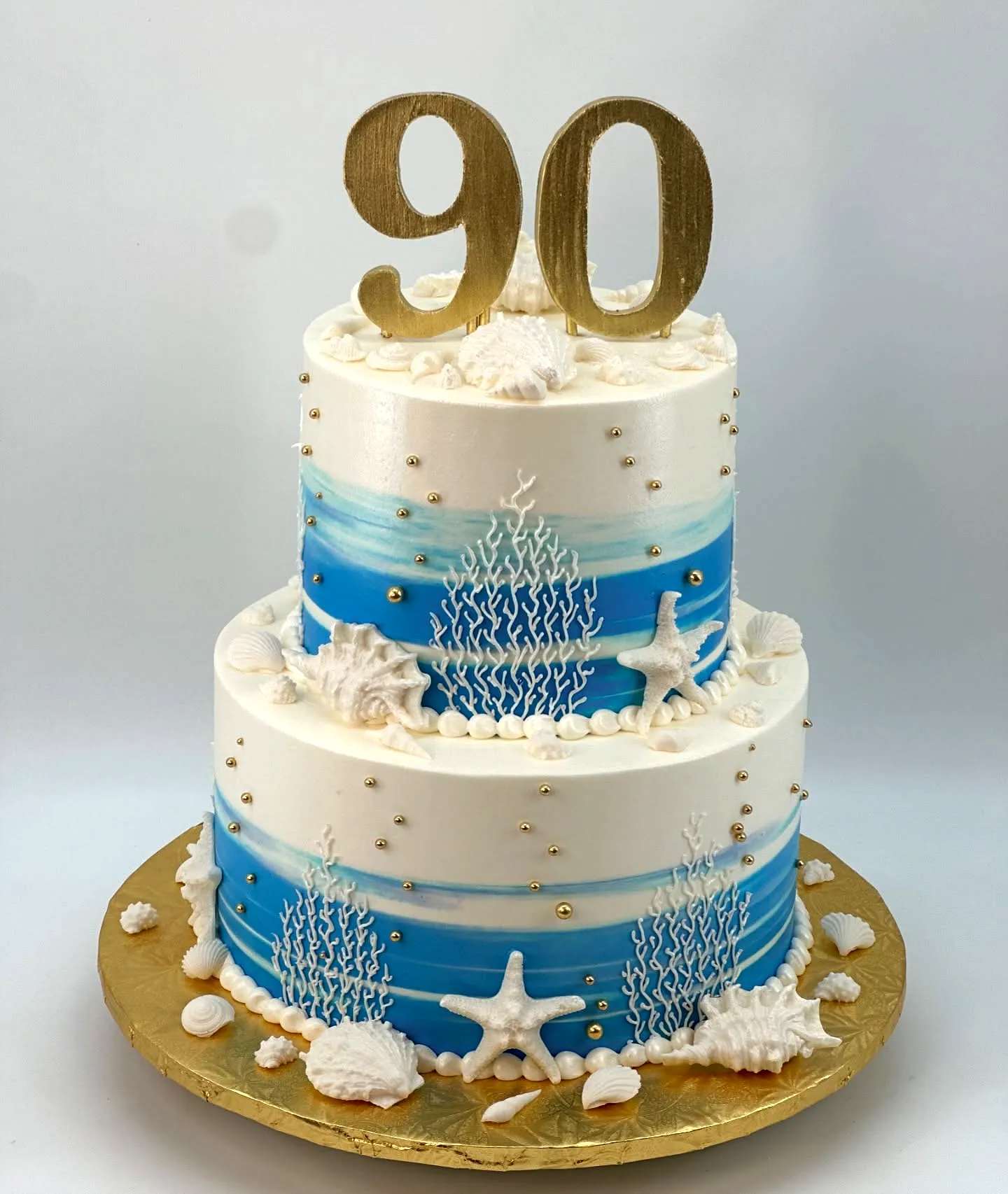 Creative ocean theme 90th birthday cake design with vibrant colors and textures