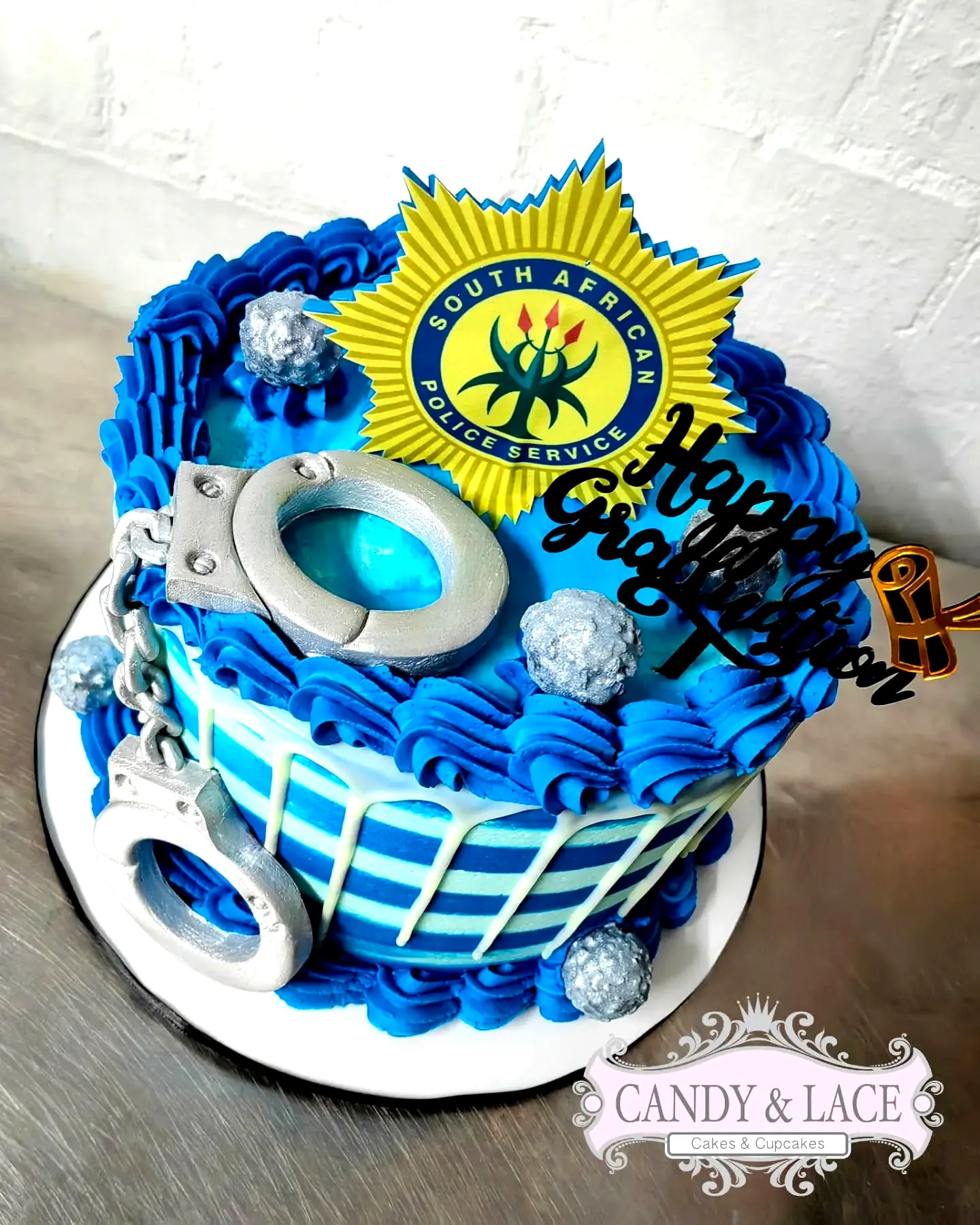 Creative police academy graduation cake design in blue and silver