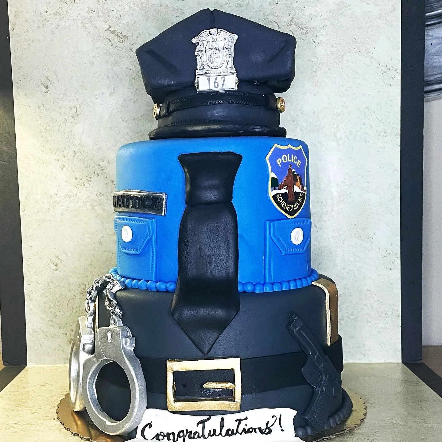 Creative police academy graduation cake design in vibrant colors and fun details