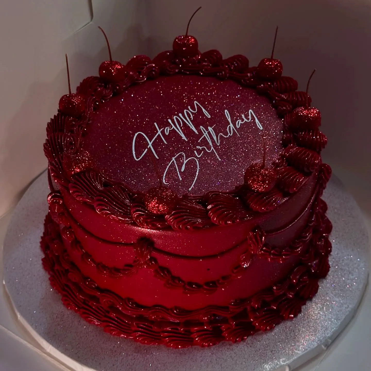 Creative Red Velvet Birthday Cake Design with Glitter and Cherry Topping